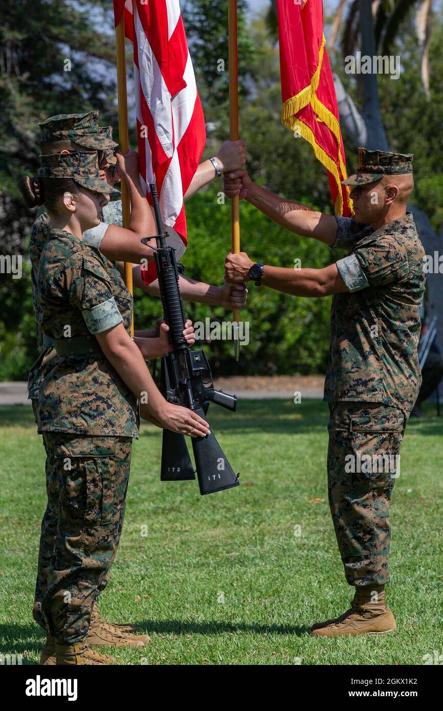 U.S. Marine Sgt. Maj. Hector Ortiz, right, the sergeant major of Security and Emergency Services Battalion, Marine Corps Base Camp Pendleton, receives the battalion colors from the color guard during a change of command at the Santa Margarita Ranch House on Camp Pendleton, California, July 14, 2021. During the ceremony, Col. Edward Greeley, the outgoing commanding officer of SES Bn., relinquished command to Col. John Black. Greeley had been the commander of SES Bn. since July 2019. Stock Photo