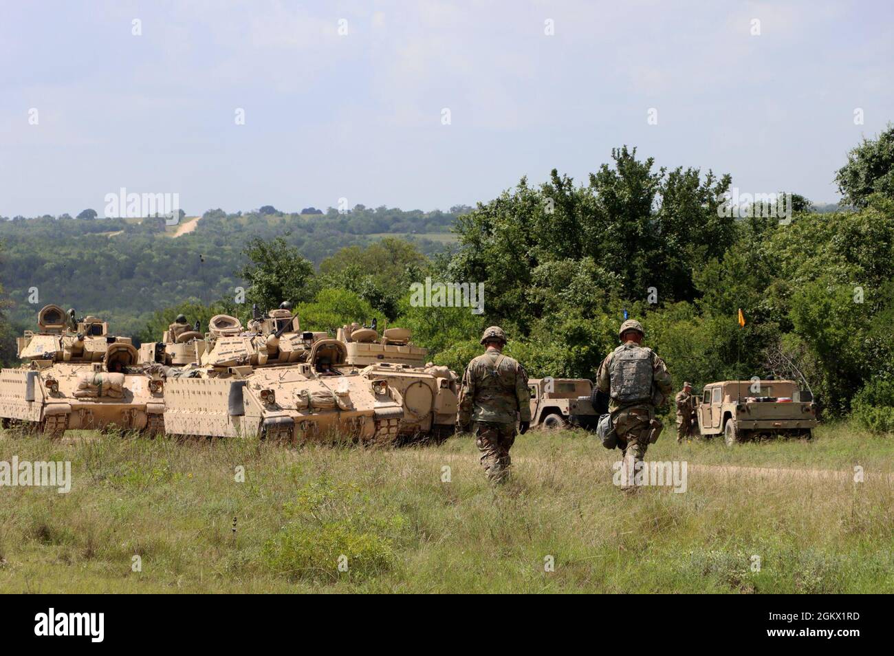 U.S. Army National Guard Staff Sgt. James Hamilton and Sgt. 1st Class Matthew Iacobucci, Observer, Coach, Trainers, with Army National Guard Operations Group Wolf prepare to evaluate Soldiers with P Troop, 4/278 Armored Reconnaissance Squadron, 278th Armored Calvary Regiment, Tennessee Army National Guard July 14, 2021 during eXportable Combat Training Capability 21-03 at Fort Hood, Texas. OCTs guide rotational units through various combat training scenarios to evaluate their proficiency in effectively conducting collect tasks. Stock Photo