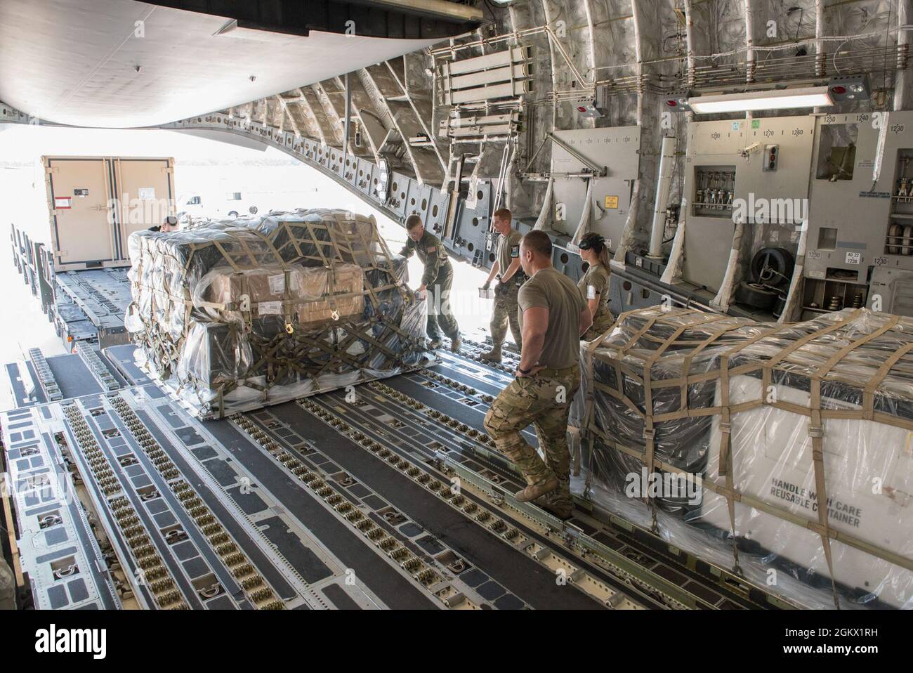 Aerial transportation specialists and loadmasters from the 167th Airlift Wing, West Virginia National Guard and 123rd Airlift Wing, Kentucky National Guard, load palletized cargo onto a C-17 Globemaster III aircraft during a cargo loading exercise at the 167th Airlift Wing, Martinsburg, West Virginia, Jul. 14, 2021. The 167th hosted members from the 123rd for a small air terminal training in preparation for their upcoming deployment. Stock Photo