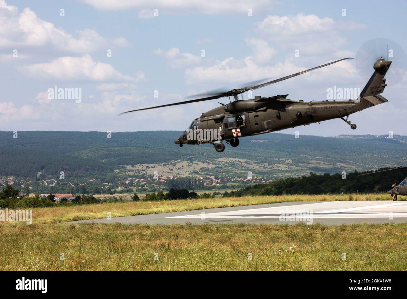 A HH-60 Blackhawk assigned to 3rd Forward Support Medical Platoon, 2nd General Support Aviation Battalion, 1st Combat Aviation Brigade, Task Force Nightmare, lifts off of the landing zone and begins its’ flight to execute MEDVAC training at Novo Selo Training Area, Bulgaria on July 14, 2021. 3FSMP, 2-1 GSAB, TF Nightmare, conducted this training as a means to maintain readiness and continue to build relationships with our NATO allies in Europe. Our ability to quickly respond and reassure allies and partners rests upon the fact that we are here, in Europe, forward and ready. Stock Photo