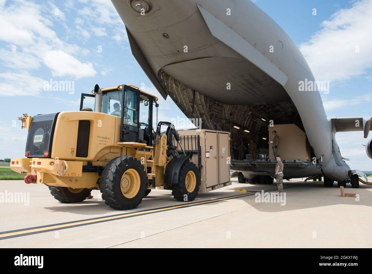 U.S. Air Force Senior Airman Alec Moser, an aerial transportation specialist with the 123rd Airlift Wing, Kentucky National Guard, uses a forklift to load contained cargo into a C-17 Globemaster III aicraft during a cargo loading exercise at the 167th Airlift Wing, Martinsburg, West Virginia, Jul. 14, 2021. The 167th hosted members from the 123rd for a small air terminal training in preparation for their upcoming deployment. Stock Photo