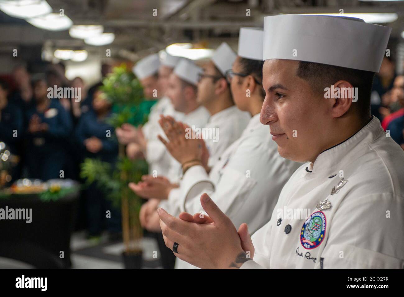 210714-N-CW176-1066 GULF OF ADEN (July 14, 2021) – Sailors participating in a cook-off event applaud on the forward mess decks of aircraft carrier USS Ronald Reagan (CVN 76) in the Gulf of Aden, July 14. Culinary specialists from different galleys around the ship came together to demonstrate their culinary skills in a head-to-head contest judged by members of the ship’s crew. Ronald Reagan is deployed to the U.S. 5th Fleet area of operations in support of naval operations to ensure maritime stability and security in the Central Region, connecting the Mediterranean and Pacific through the weste Stock Photo