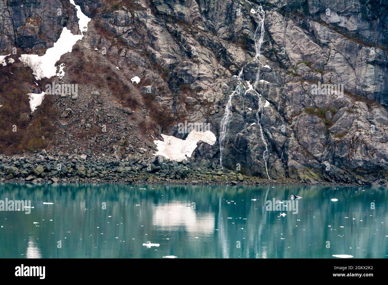 Ice and snow melt cascading down a rocky slope in Glacier Bay National