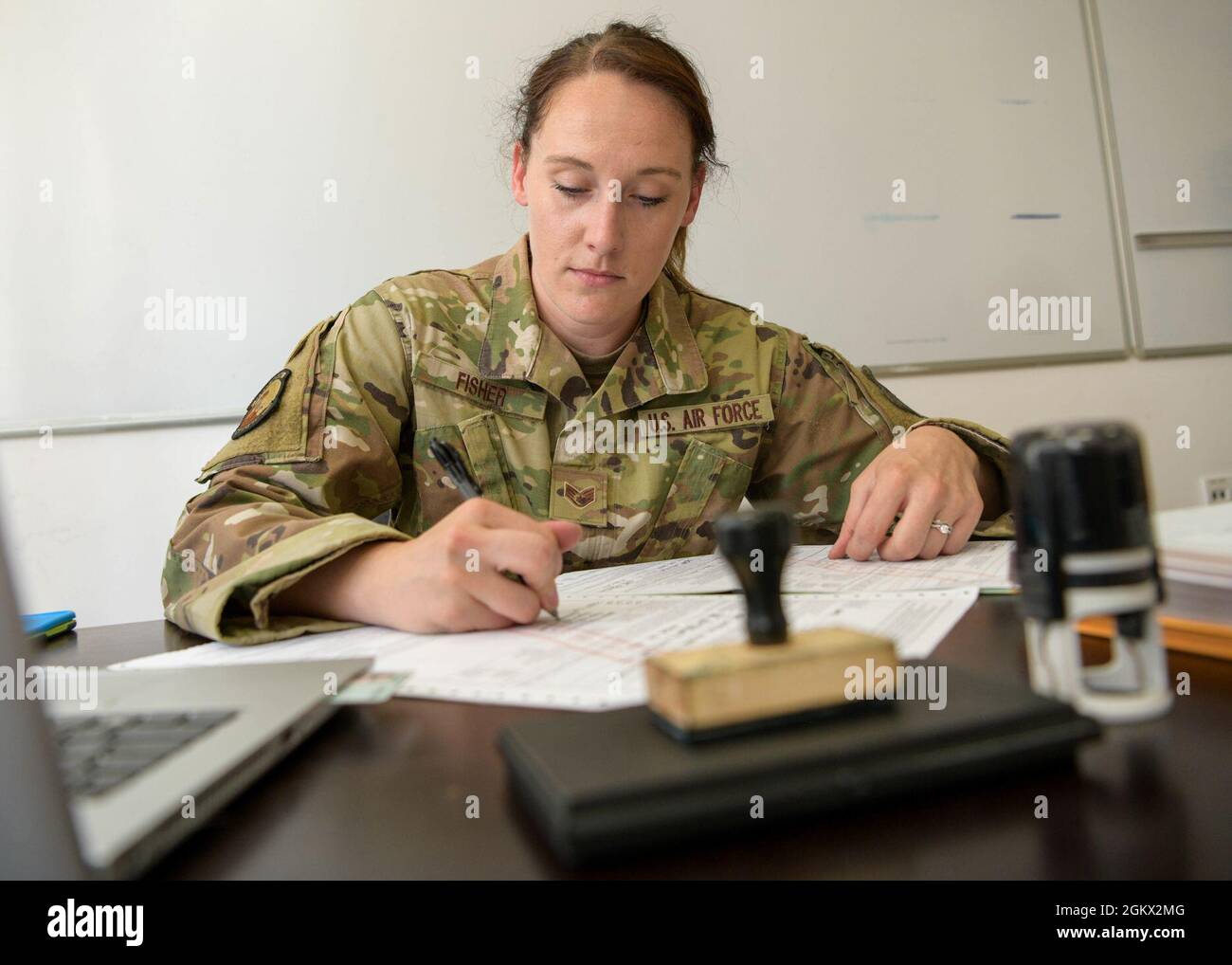 U.S. Air Force Staff Sgt. Kaitlyn Fisher, 31st Logistics Readiness Squadron traffic management office customs clearance officer, clears AE 302 customs import documents during exercise Thracian Star 21 at Graf Ignatievo Air Base, Bulgaria, July 14, 2021. An AE 302 customs report allows military cargo to travel through NATO countries without being subject to taxes. Stock Photo