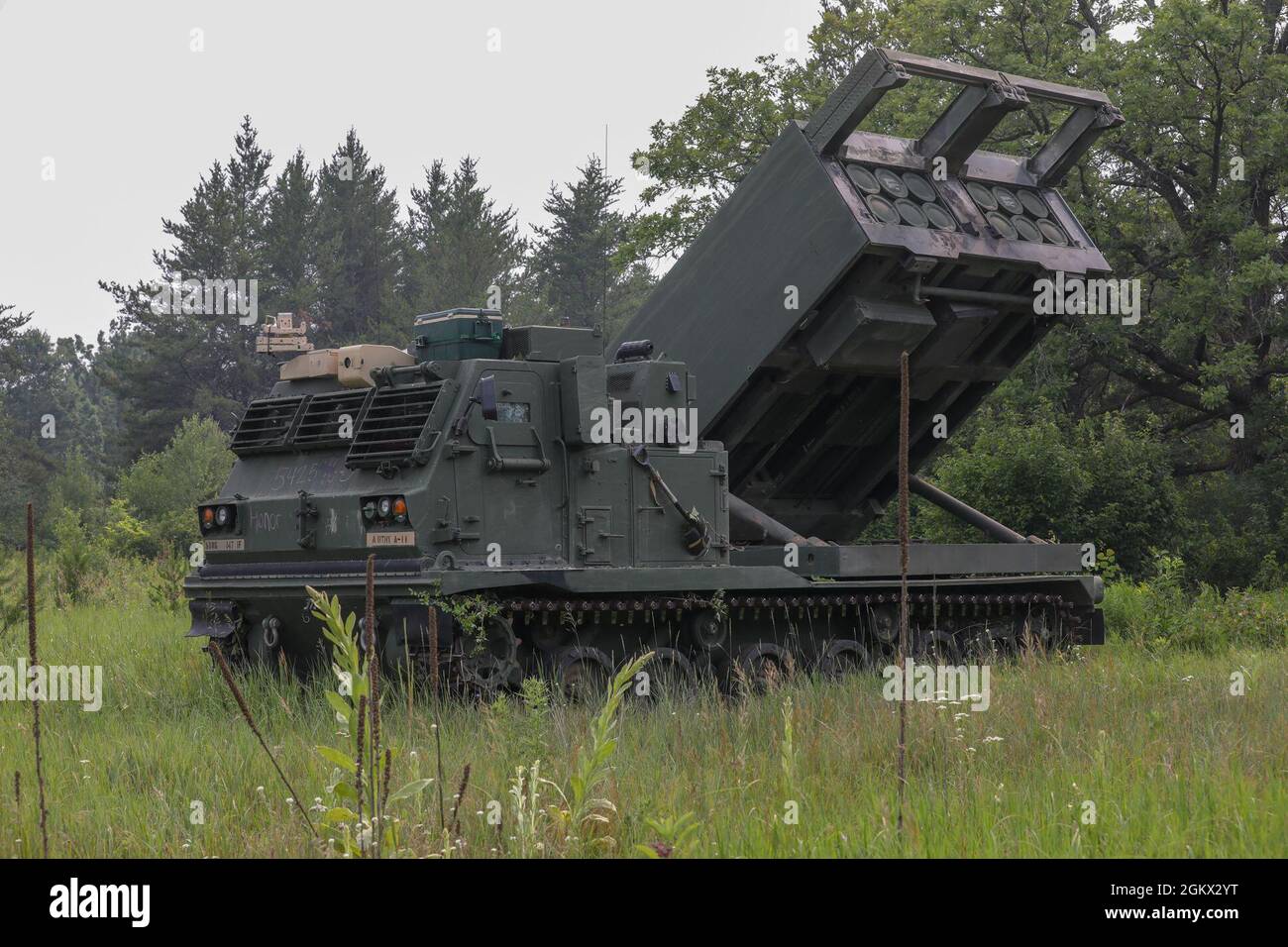 An M270A1 MLRS from the 1-147th FA, South Dakota National Guard, conducts a practice field reload during their annual training at Camp Ripley Training Center, Minnesota on July 15, 2021. The main mission of the 1-147th FA is to deliver precision fire on enemies both near or far and can hit targets up to 300 kilometers away. Stock Photo