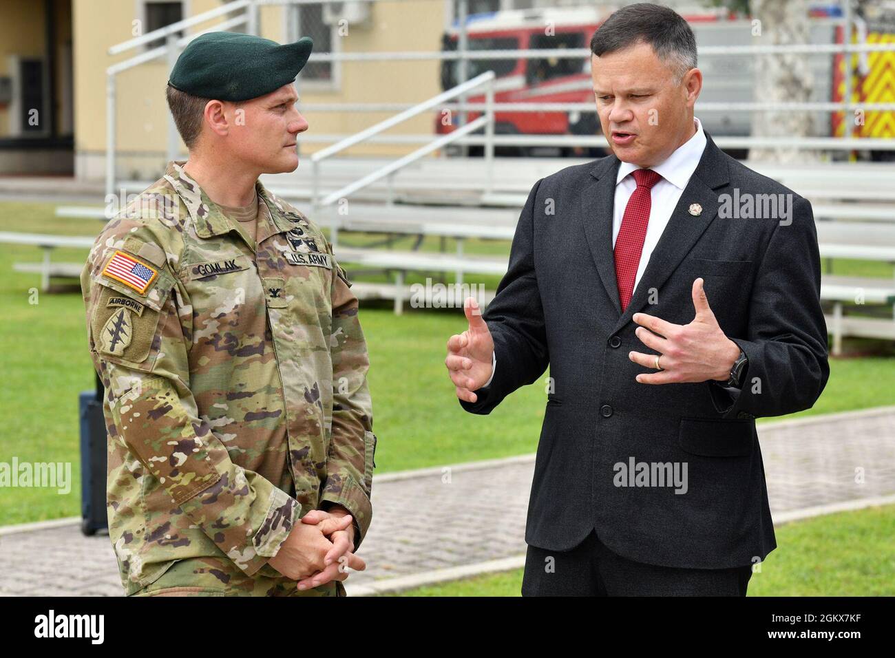 Mr. Tommy R. Mize, Installation Management Command Europe Region Director, right, speaks with U.S. Army Col. Matthew J. Gomlak, incoming commander of U.S. Army Garrison Italy, left, during change of command ceremony under Covid-19 prevention condition at Caserma Ederle, Vicenza, Italy July 16, 2021. Stock Photo