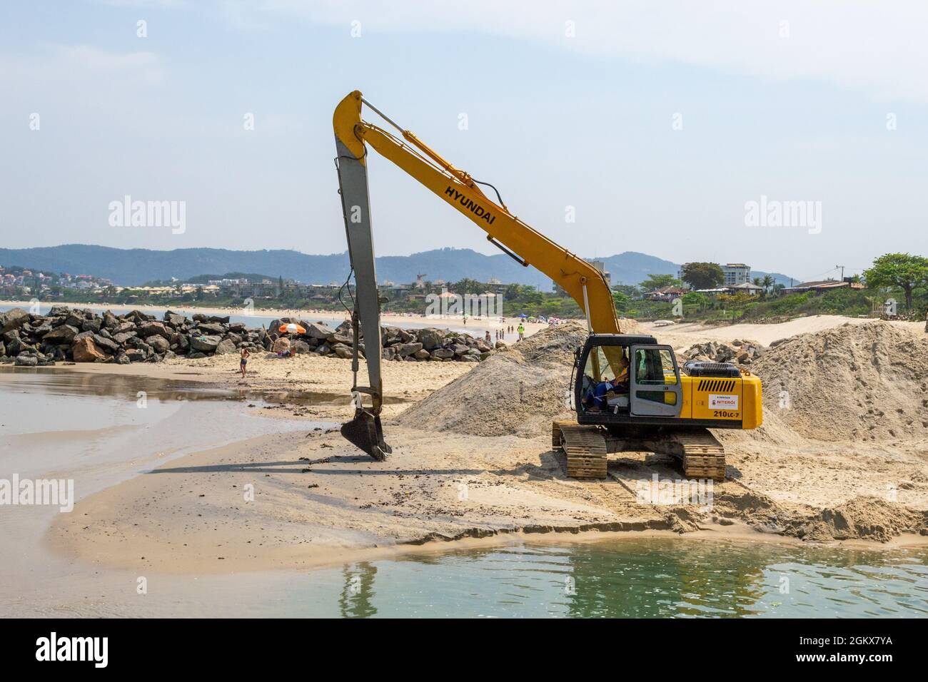 Construction equipment for moving  sand in Itaipu Beach, Rio de Janeiro, Brazil. The famous place is a major tourist attraction. Stock Photo