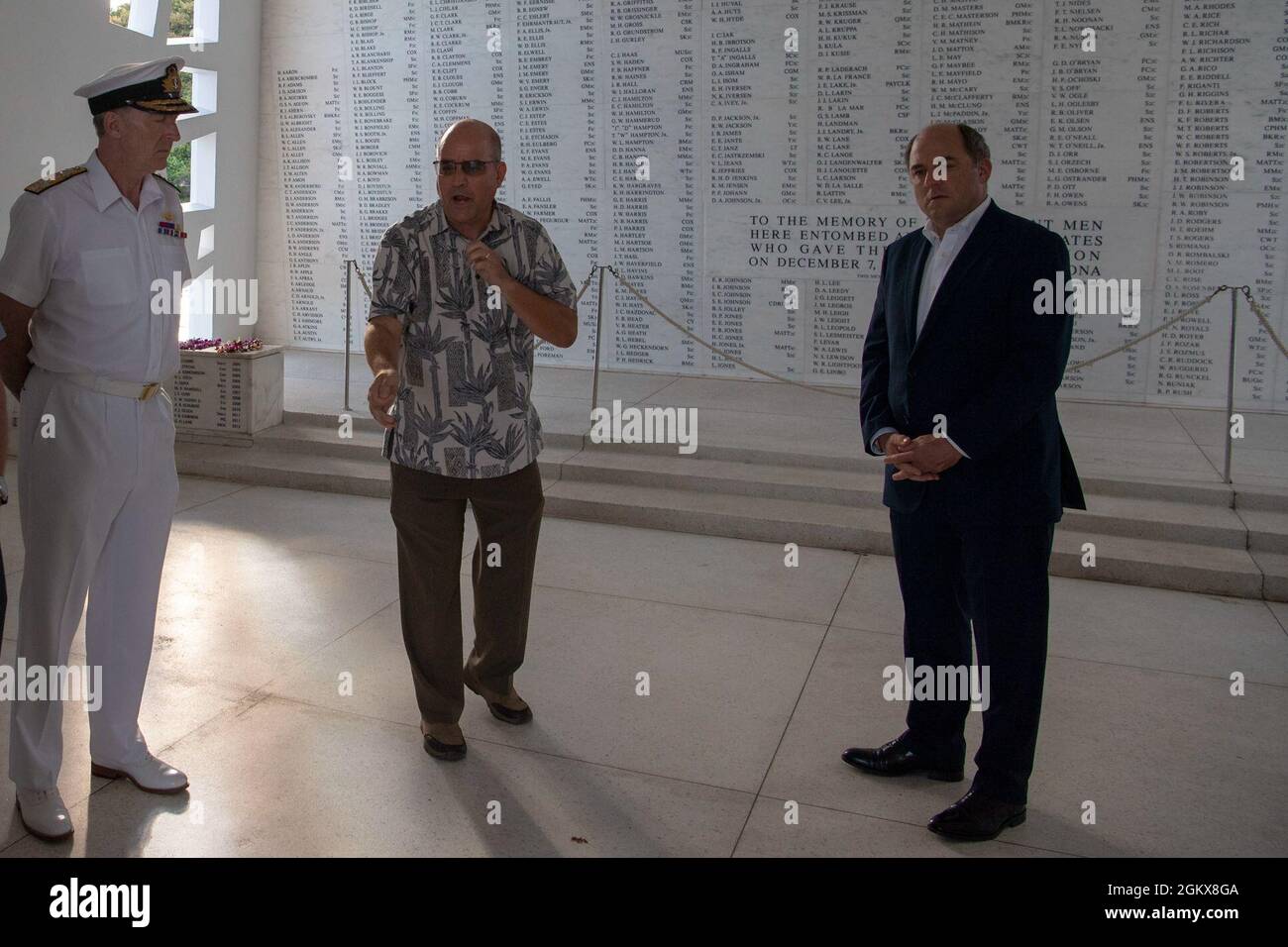 PEARL HARBOR, Hawaii (July 16, 2021) U.K. Secretary of State for Defence Ben Wallace, right, and U.K. First Sea Lord and Chief of Naval Staff Adm. Tony Radakin, left, participate in a tour of the USS Arizona Memorial led by Navy Region Hawaii historian James Neuman, July 16. The visit emphasized the importance of the U.K.-U.S. defense partnership and interoperability between like-minded international partners in the Indo-Pacific region. Stock Photo