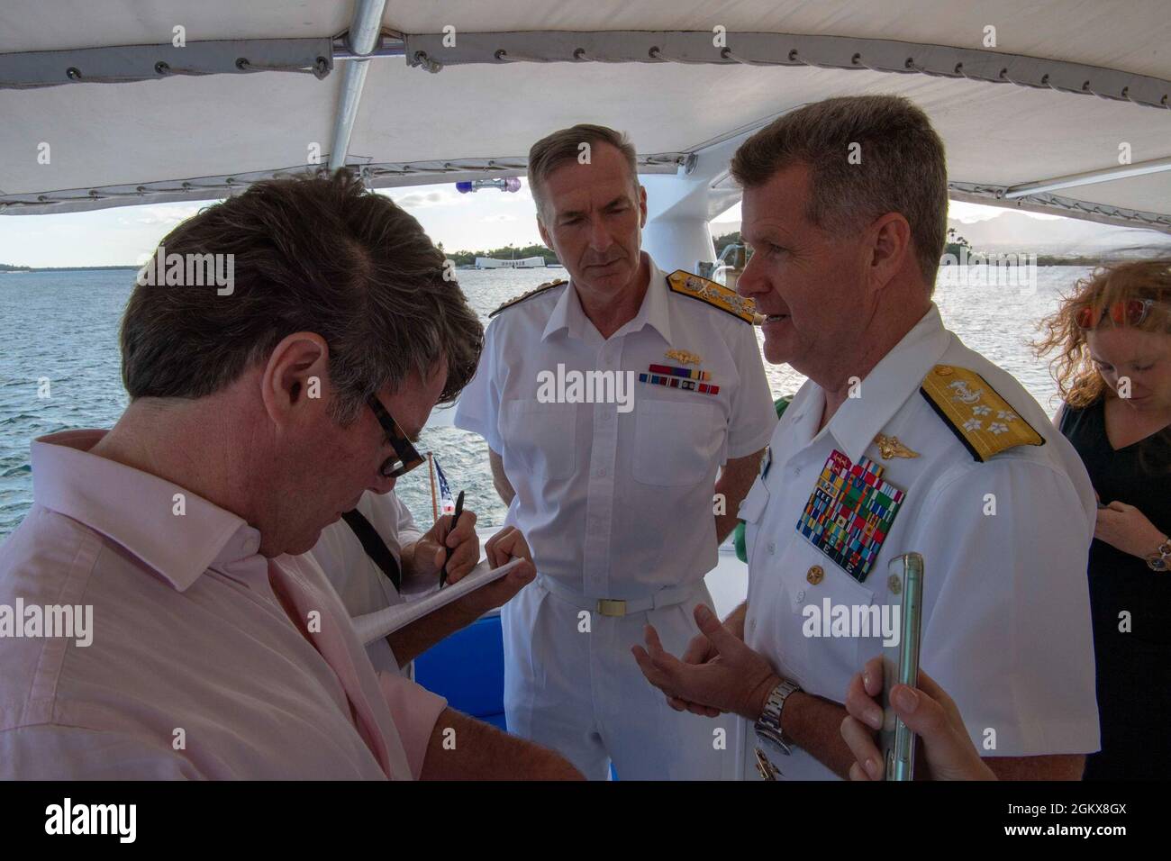 PEARL HARBOR, Hawaii (July 16, 2021) Adm. Samuel Paparo, Commander of U.S. Pacific Fleet, right, and Royal Navy Adm. Tony Radakin, First Sea Lord and Chief of Naval Staff, spoke with reporters following a tour of the USS Arizona Memorial. The leaders discussed the importance of the U.K.-U.S. defense partnership and interoperability between like-minded international partners in the Indo-Pacific region. Stock Photo