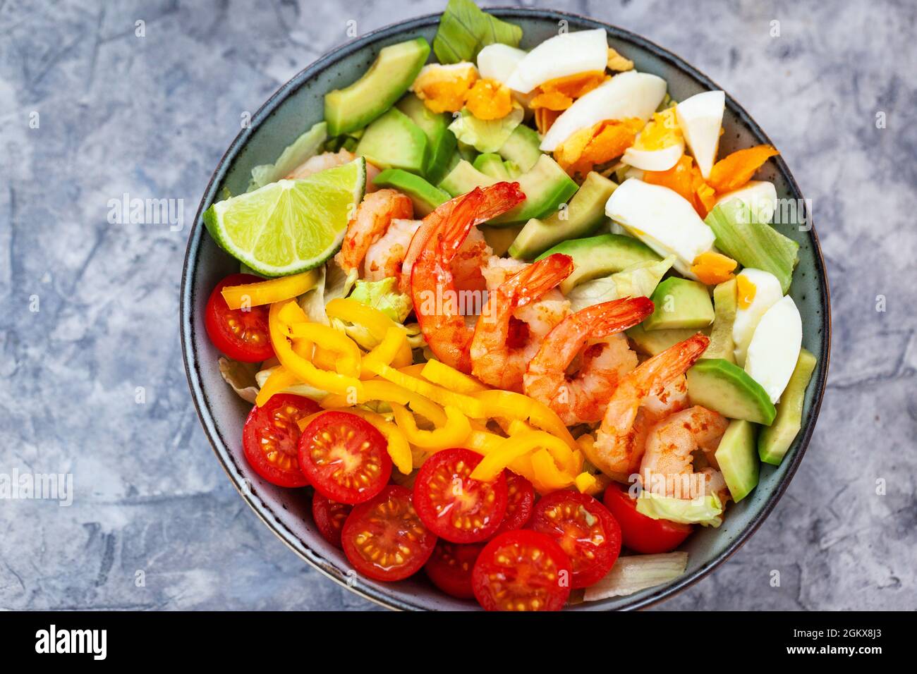 Delicious fresh salad with prawns, avocado, eggs, bell pepper, tomatoes
