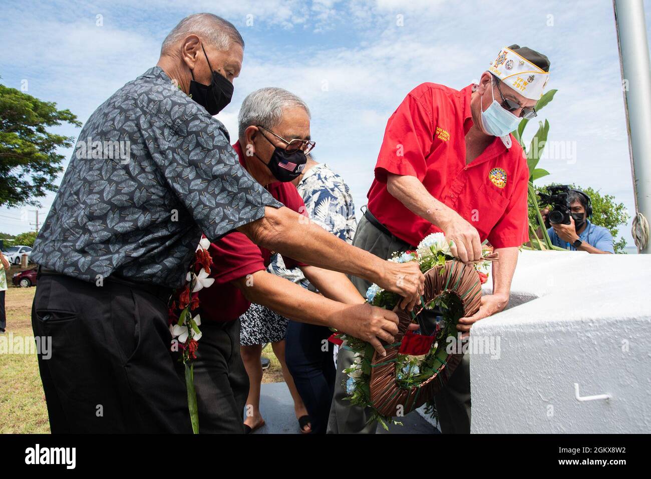 ASAN, Guam (July 19, 2021) -  Asan-Maina Mayor Frankie Salas joins the VFW Post 2917 as they lay a wreath during the Asan Beach Landing Memorial ceremony July 16. Military service members, local government officials and residents gathered to recall the U.S. military’s liberation of Guam during World War II. The site of the ceremony is where the 3rd Marine Division planted the U.S. flag after securing the beachhead. Approximately 55,000 Marines and Army soldiers participated in the battle for Guam. More than 1,800 American service members were killed in action or died of wounds during the first Stock Photo