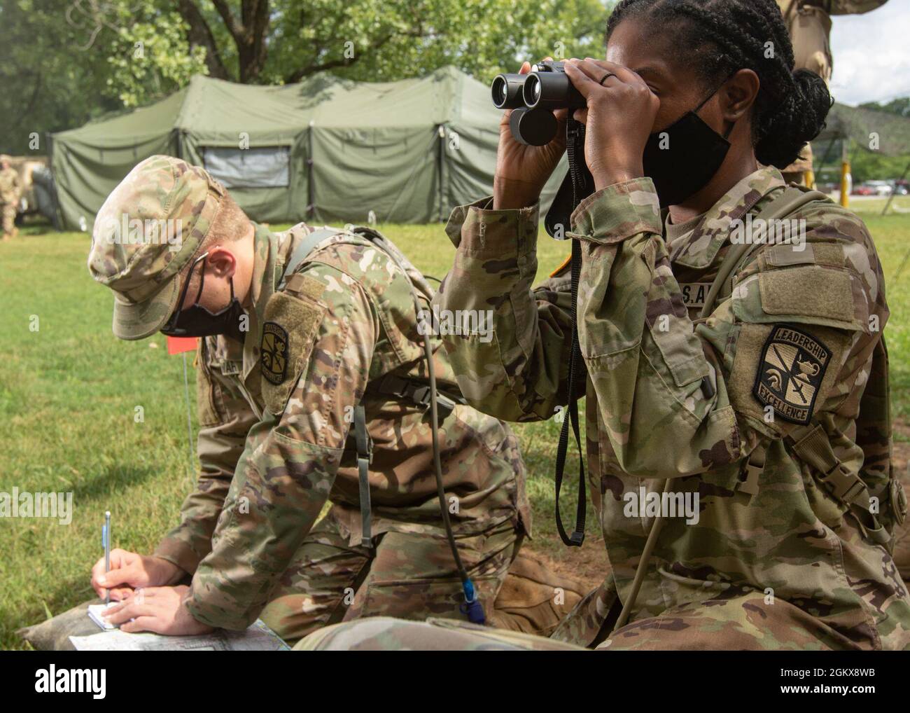 Cadets Raquel Piercey, University of Texas at El Paso, and Tyler Stewart, Colorado School of Mines, plan adjustments on a map as they call for simulated artillery to strike as part of Call for Fire during the Warrior Skills portion of Cadet Summer Training at Fort Knox, Ky., on July 16, 2021. Stock Photo