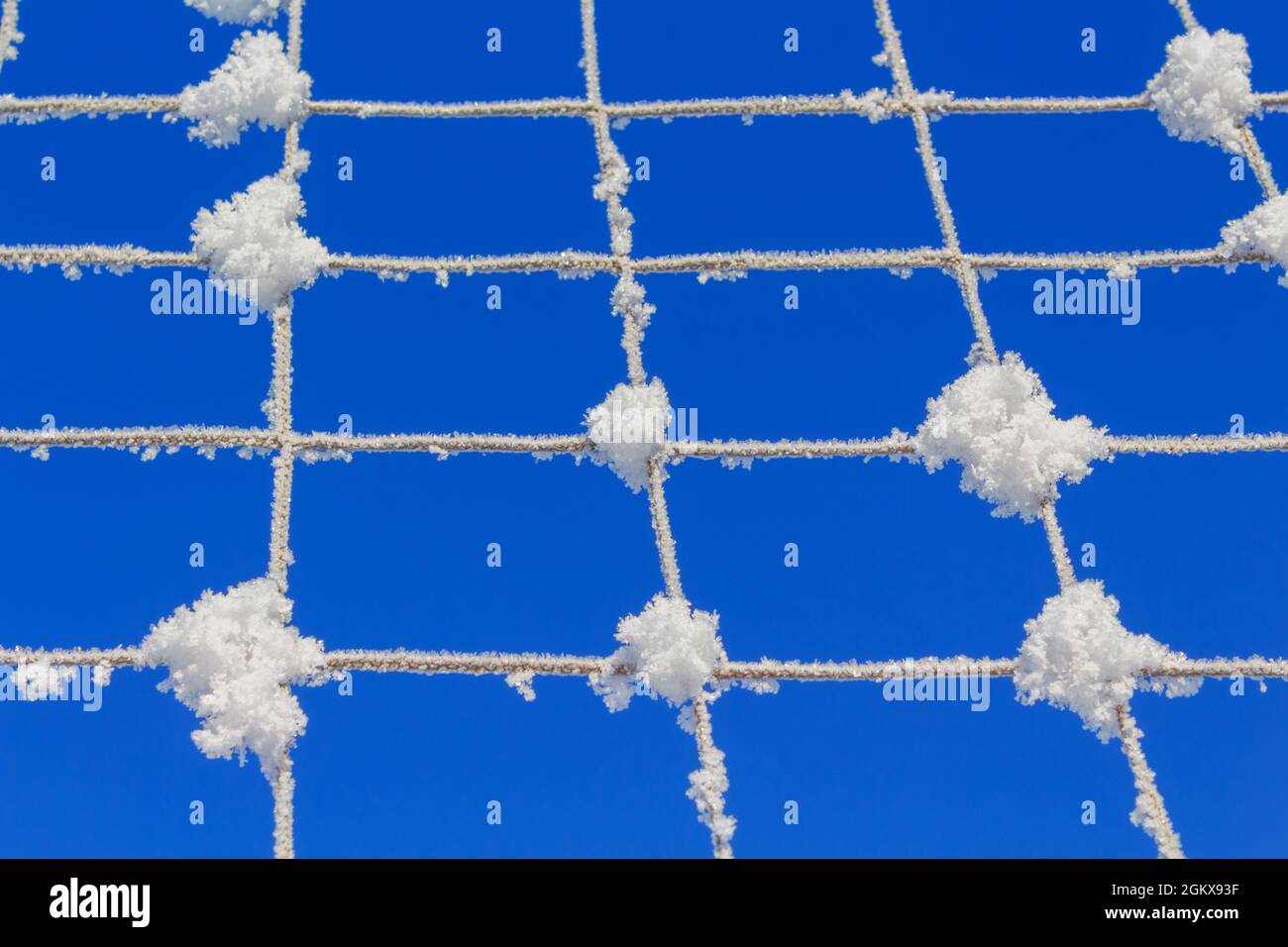 Volleyball net covered with snow. Nature's minimalism.  Stock Photo