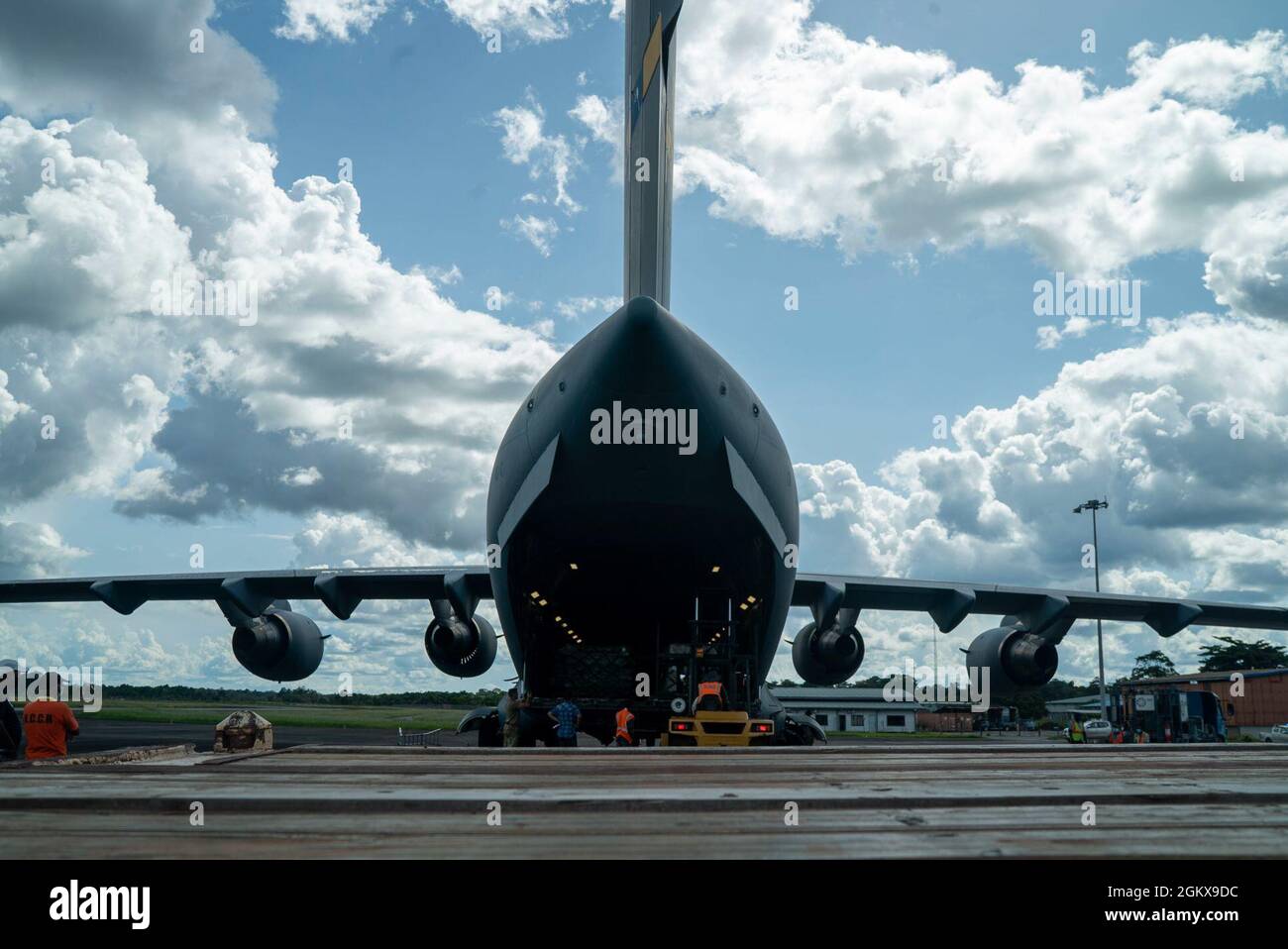 U.S. Air Force personnel and Surinamese locals unload field hospital equipment at Johan Adolf Pengel International Airport, Suriname, July 16, 2021. The portable field hospital, valued at $745,000, was donated by U.S. Southern Command Stock Photo
