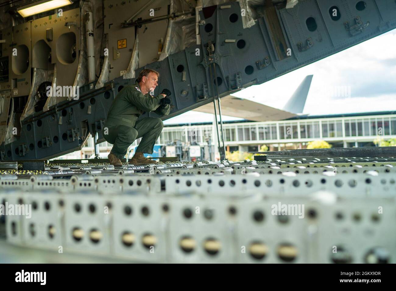 Master Sgt. Don Rix, 701st Airlift Squadron loadmaster, directs a forklift at Johan Adolf Pengel International Airport, Suriname, July 16, 2021. The portable field hospital, valued at $745,000, was donated by U.S. Southern Command Stock Photo