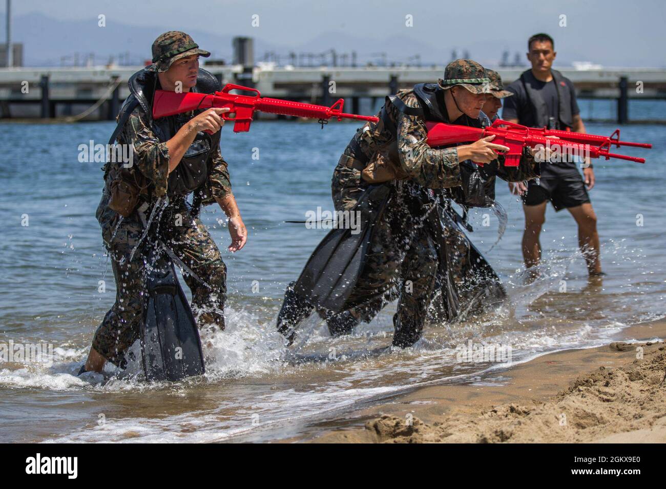 U.S. Marines with Co. C, 1st Battalion, 5th Marine Regiment, 1st Marine Division, practice securing the shore during a Scout Swimmer Course on Naval Amphibious Base Coronado, California, July 16, 2021. The Marines learned the skills necessary to plan and execute swimmer reconnaissance for a small boat raid company in preparation for deployment. Stock Photo