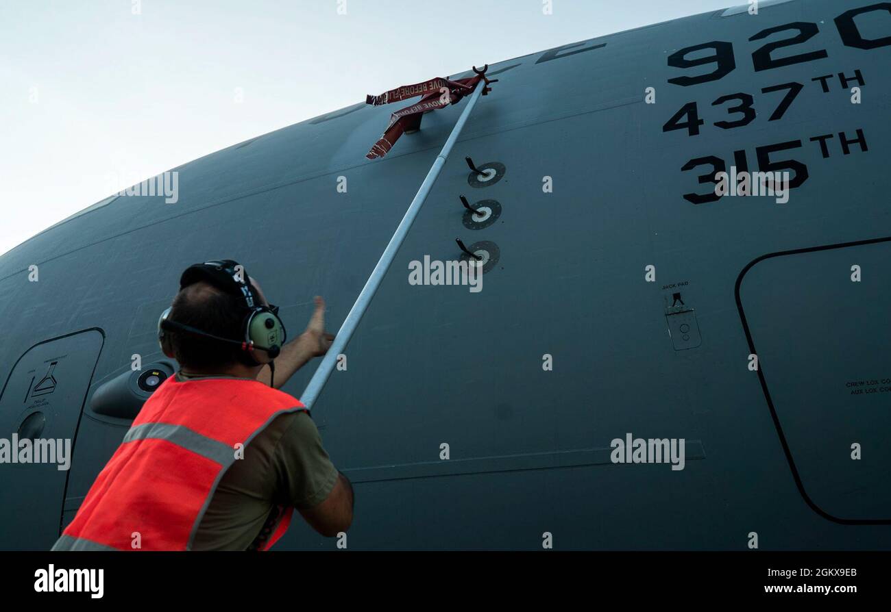 A U.S. Air Force maintainer with the 315th Airlift Wing removes a pitot tube cover before departing to Johan Adolf Pengel International Airport, Suriname from Joint Base Charleston, South Carolina, July 16, 2021. The portable field hospital, valued at $745,000, was donated by U.S. Southern Command Stock Photo