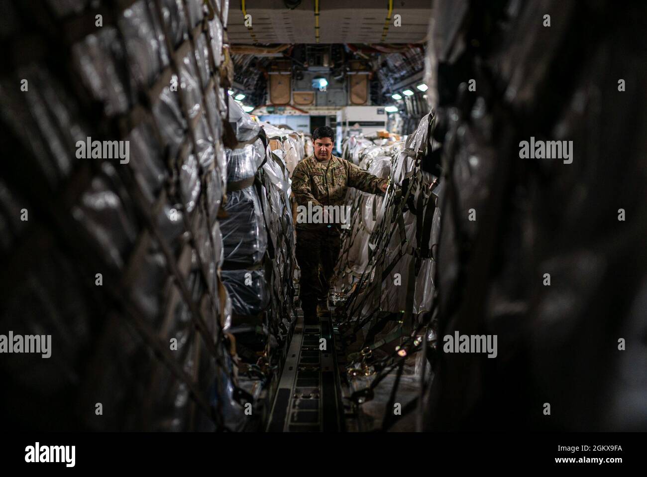Staff Sgt. Dwayne Baldwin, 701st Airlift Squadron loadmaster, inspects cargo before departing to Johan Adolf Pengel International Airport, Suriname from Joint Base Charleston, South Carolina, July 16, 2021. The portable field hospital, valued at $745,000, was donated by U.S. Southern Command Stock Photo