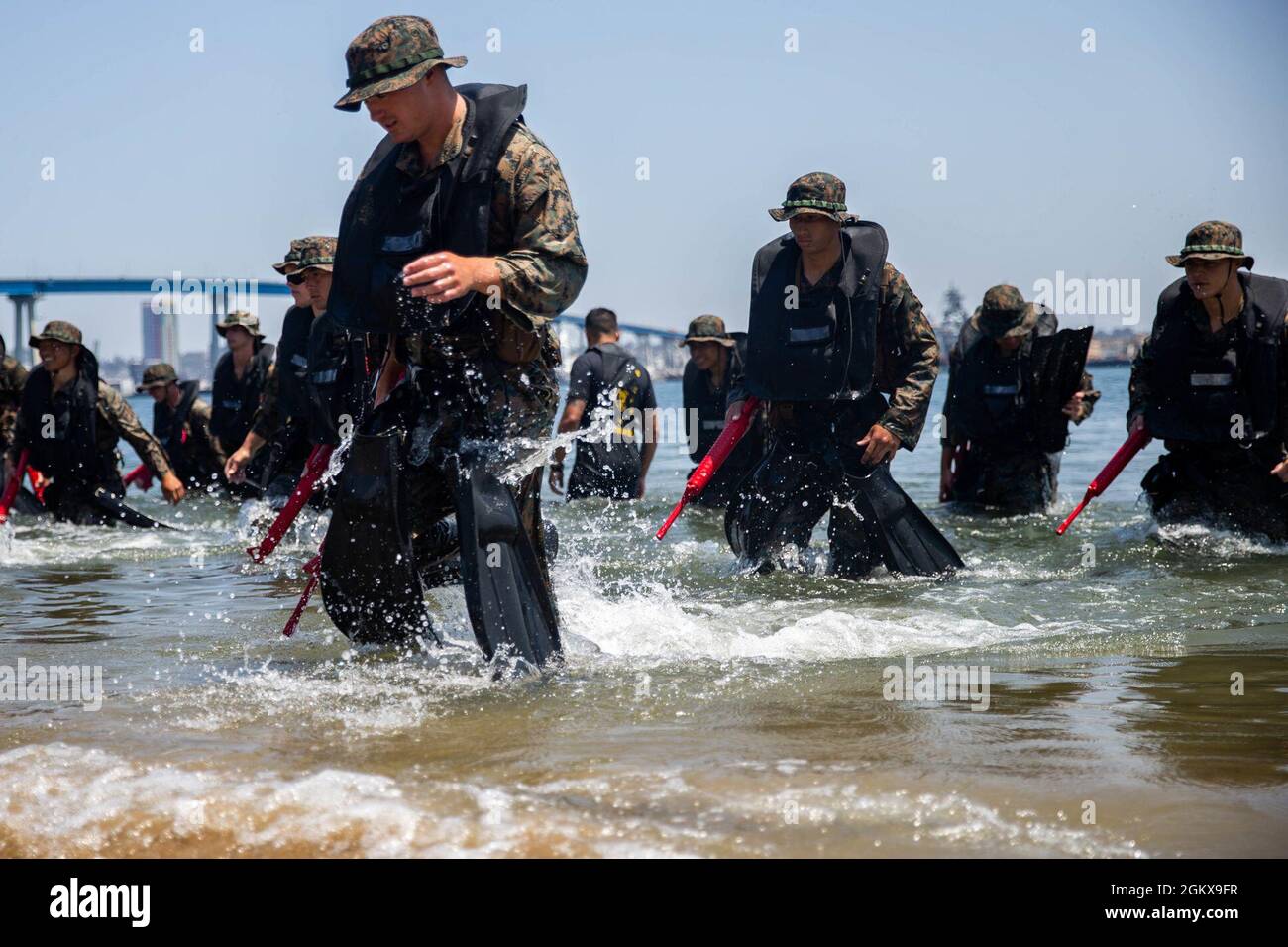 U.S. Marines with Co. C, 1st Battalion, 5th Marine Regiment, 1st Marine Division, make their way to shore after executing rescue drills during a Scout Swimmer Course on Naval Amphibious Base Coronado, California, July 16, 2021. The Marines learned the skills necessary to plan and execute swimmer reconnaissance for a small boat raid company in preparation for deployment. Stock Photo