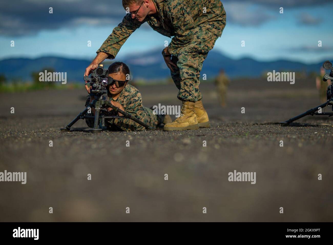 U.S. Marines with Marine Wing Support Squadron (MWSS) 171, familiarize themselves with an M240B machine gun during exercise Eagle Wrath 21 at Combined Arms Training Center (CATC) Camp Fuji, Japan, July 16, 2021. Eagle Wrath is an annual MWSS-171 exercise at CATC Camp Fuji, Japan, designed to increase squadron proficiency in conducting real-world contingency missions while in a forward operating environment. Stock Photo