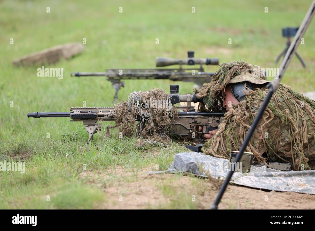 Camouflaged woman sniper in ghillie suit posing with rifle in foggy night.  Special Weapons and Woman Concept Stock Photo - Alamy