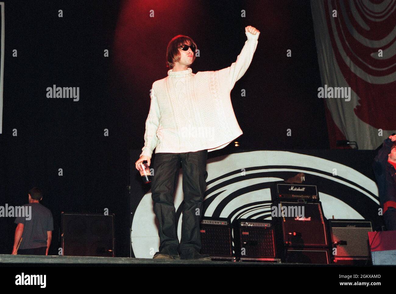 Liam Gallagher salutes the 250,00 crowd before performing live onstage with Oasis on the second night of concerts at Knebworth, August 1996 Stock Photo