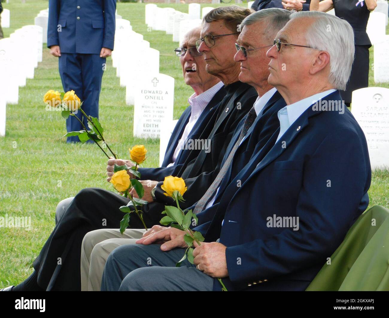 The four sons of Major Harvey Storms listen to a graveside service for their father who was buried in Arlington National Cemetery on July 16, 2021. Major Storms was reported missing in action on Dec. 1, 1950, when his unit was attacked by enemy forces near the Chosin Reservoir, North Korea. Following the battle, his remains could not be recovered. The Defense POW/MIA Accounting Agency was able to identify the remains in 2019. (Defense Photo by Ashley M. Wright) Stock Photo