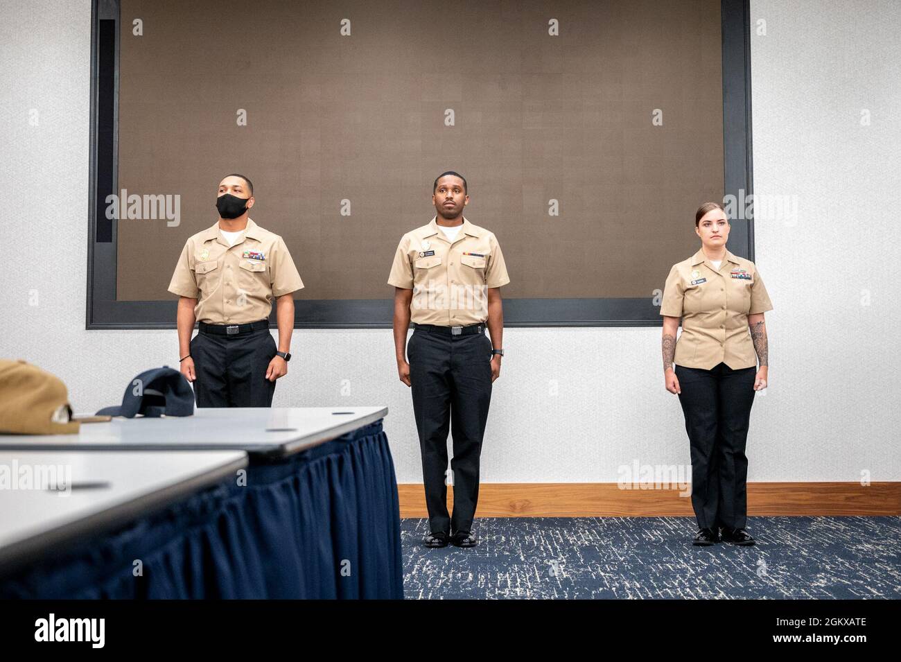 WASHINGTON, DC (July 16, 2021) – Naval Support Activity Washington masters-at-arms stand at attention prior to being frocked to the next rate onboard Washington Navy Yard. Stock Photo