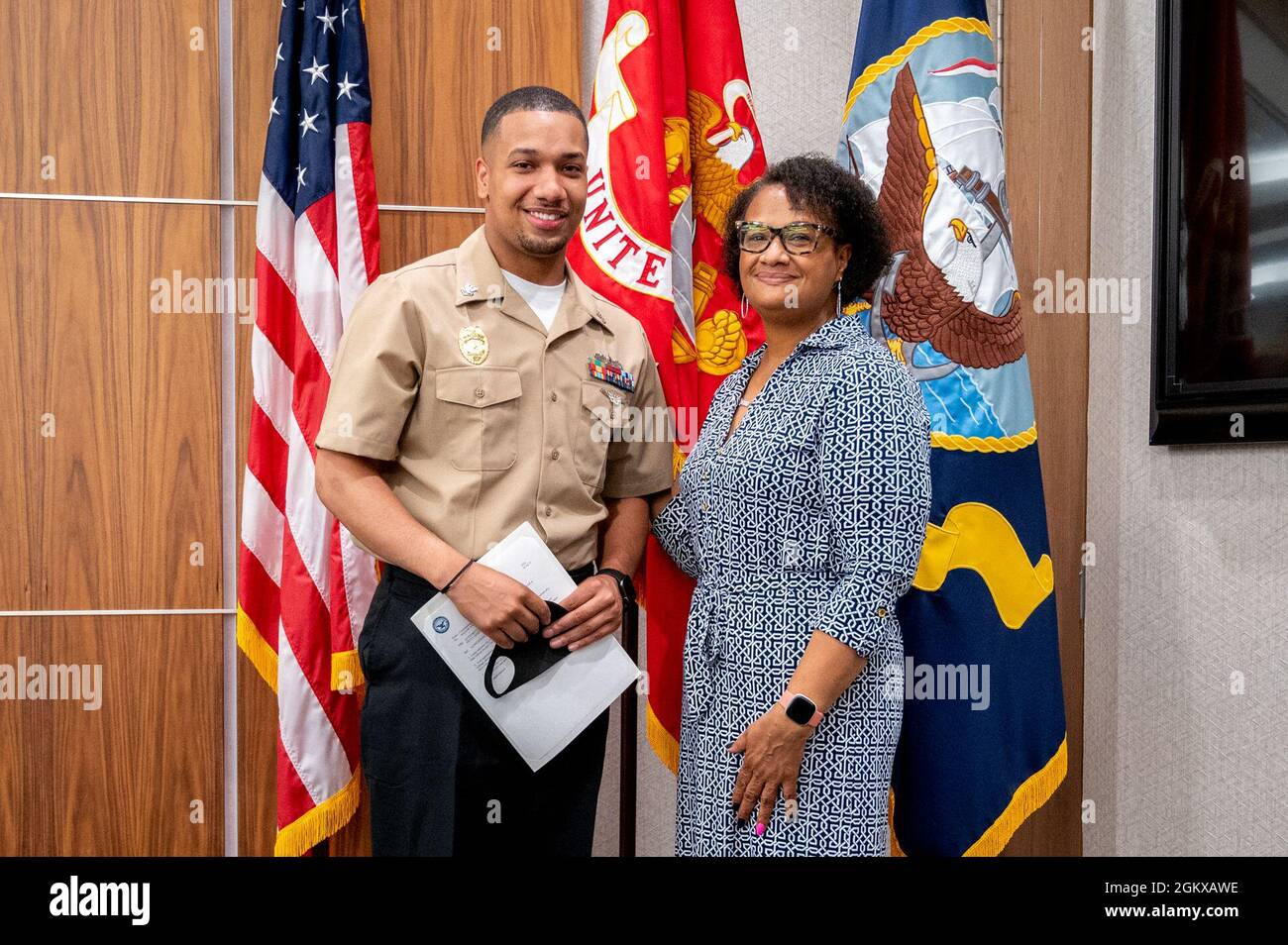 WASHINGTON, DC (July 16, 2021) – Master-at-Arms 2nd Class Najee Gravesande, left, poses with a family member following a frocking ceremony held onboard Washington Navy Yard. Stock Photo