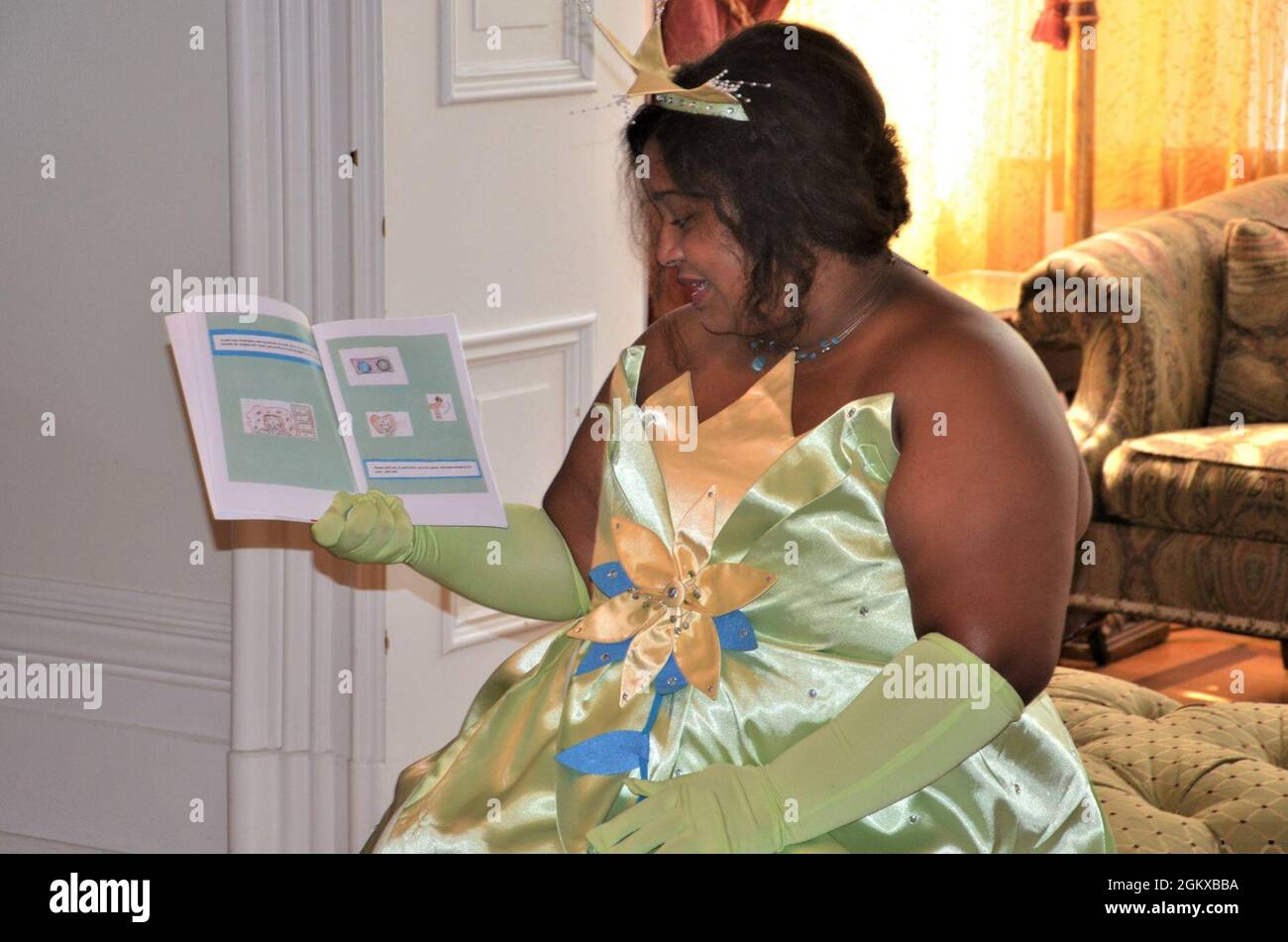 Princess Tiana (Alexis Boeh-Peterson), spins some magic with a story to her group of princes and princesses during the “Storytime with Princesses” event held at Rock Island Arsenal, Illinois, July 17. Stock Photo