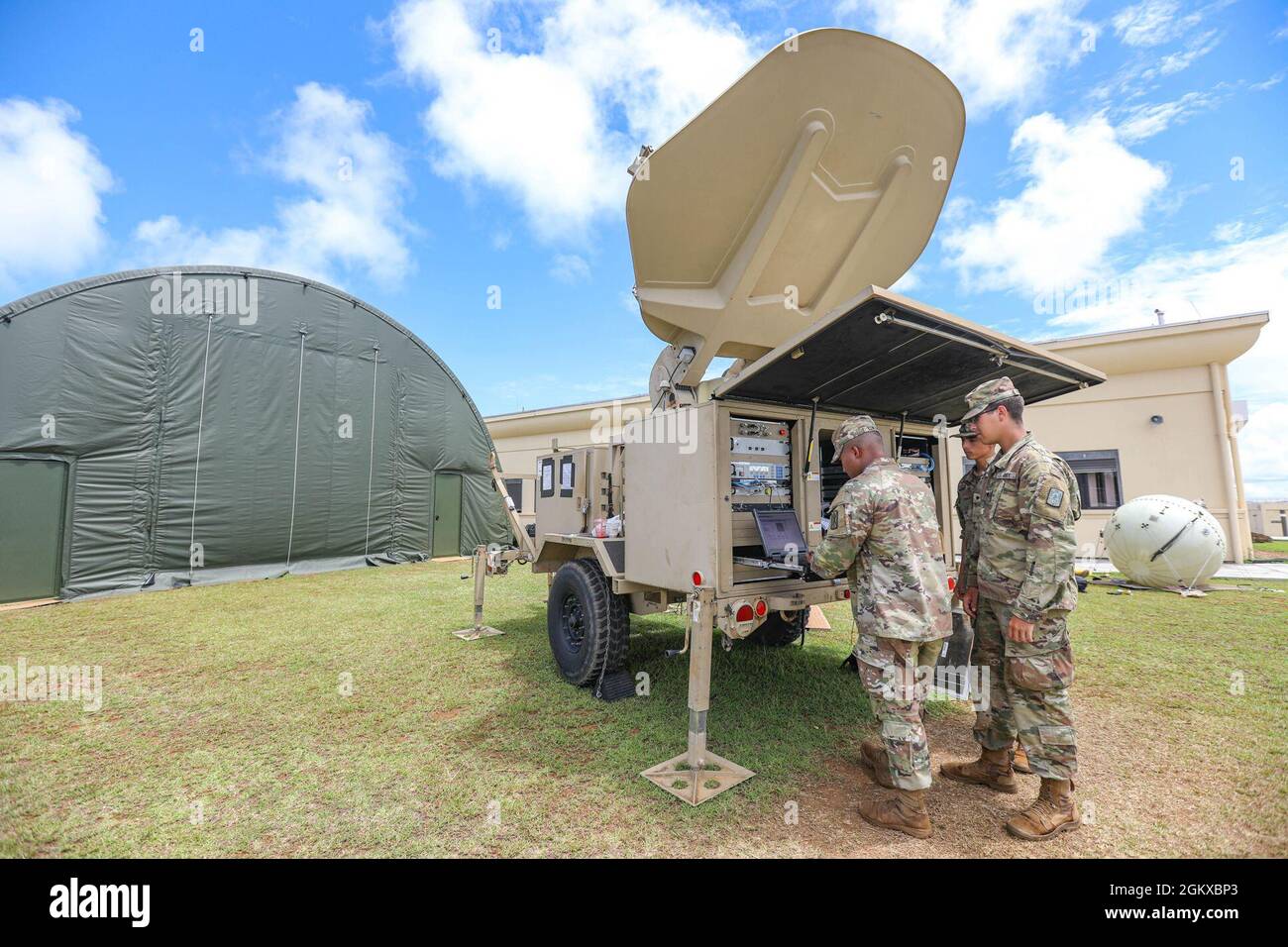U.S. Army Soldiers from the 307th Expeditionary Signal Battalion, 516th Signal Brigade out of Fort Shafter, Hawaii, and 40th ESB, 11th Corps Signal Brigade out of Fort Huachuca, Arizona, work together to establish satellite communication support for Exercise Forager 21 at Guam National Guard Headquarters July 17, 2021. Forager 21 is a U.S Army Pacific exercise designed to showcase mission readiness and utilize multi-domain capabilities in a joint environment in the Pacific Theater. Stock Photo