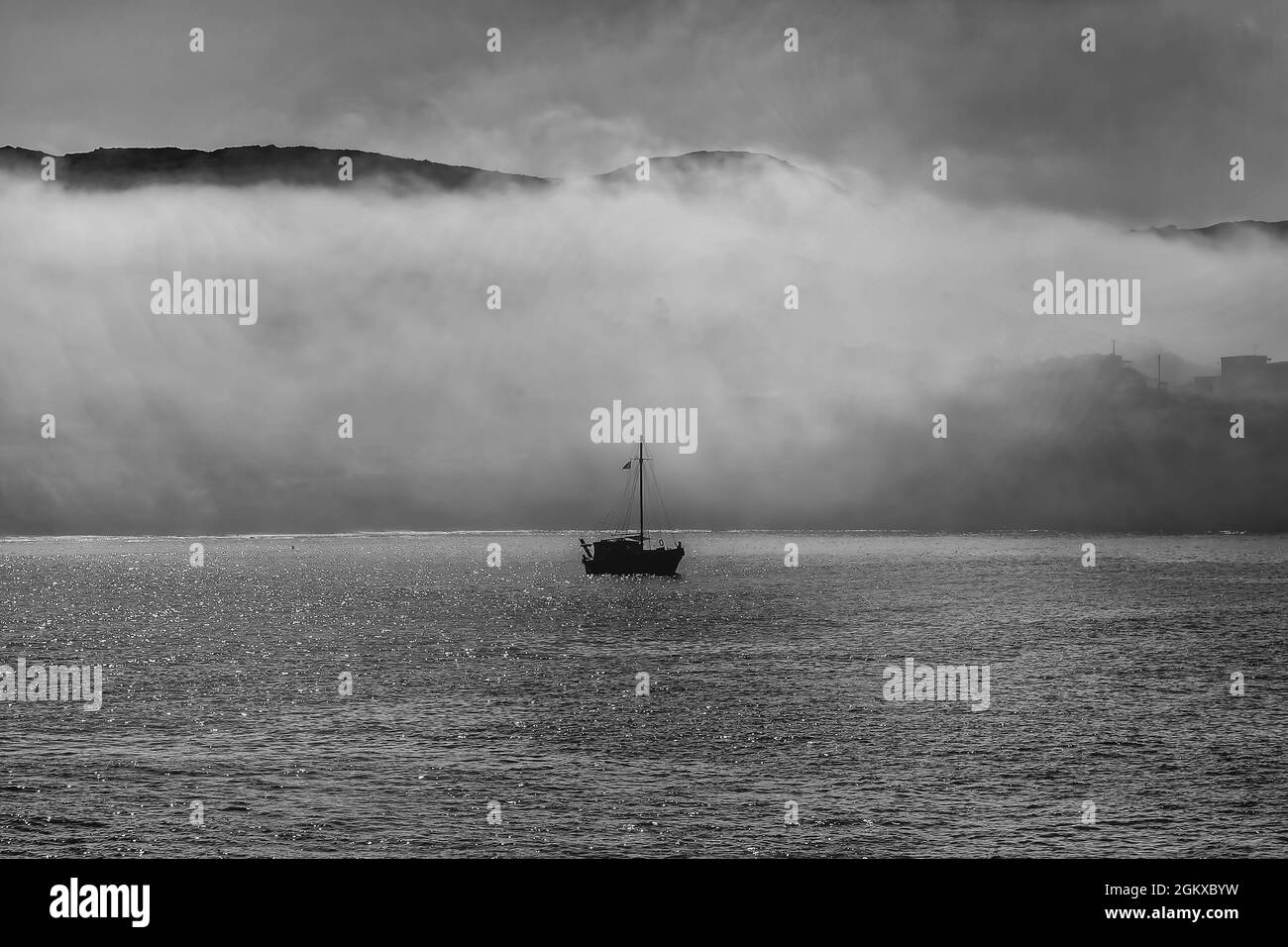 Silhouette Boat In Fog. Fishing boat in the Mediterranean early morning in Summer. Stock Image Stock Photo