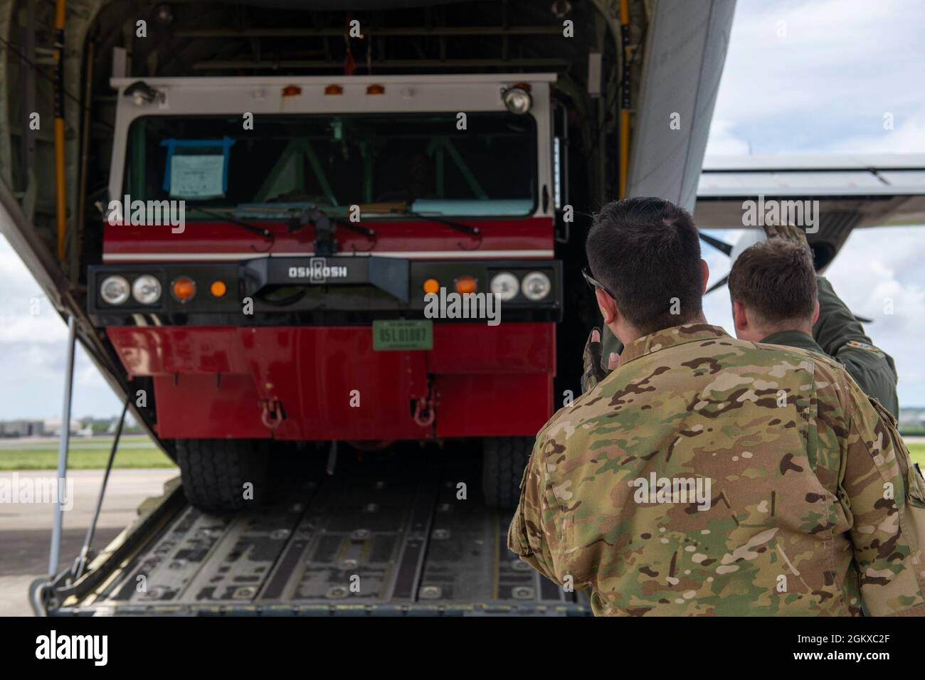 Staff Sgt. Alex Watson and Senior Airman Spencer Kans, 36th Airlift Squadron loadmasters from Yokota Air Base, Japan, assist a P-19 firetruck onto a C-130J Super Hercules July 17, 2021, on Kadena Air Base, Japan in support of Pacific Iron 2021. Approximately 800 Airmen and 35 aircraft are participating in Pacific Air Forces’ dynamic force employment operation July 11 to Aug. 8, 2021, in Guam and Tinian to project forces into U.S. Indo-Pacific Command’s area of responsibility in support of the 2018 National Defense Strategy, calling on the military to be a more lethal, adaptive and resilient fo Stock Photo