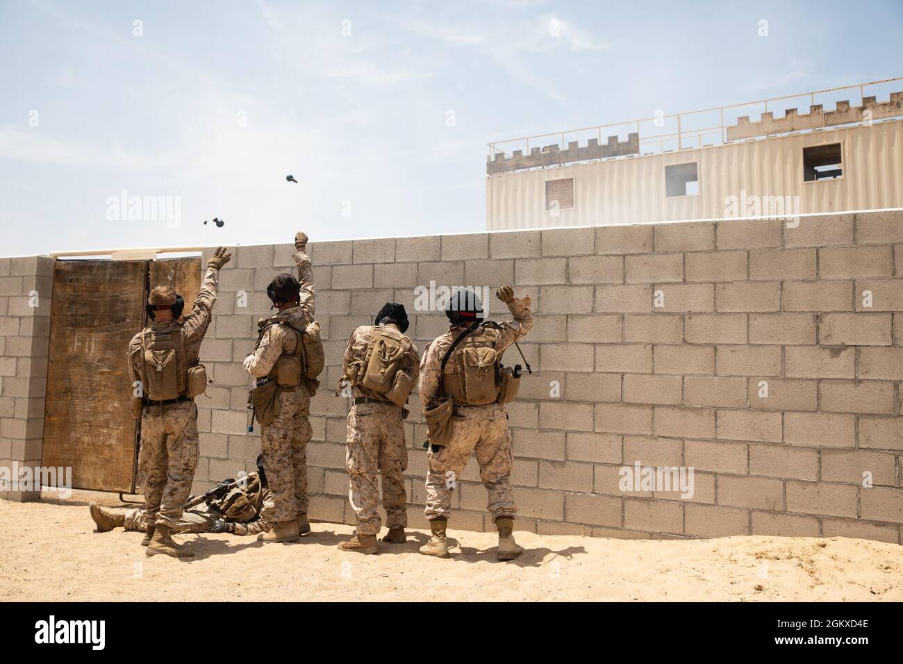 U.S. Marines with Co. L, 3rd Battalion, 4th Marine Regiment, 1st Marine Division, throw M69 blue body hand grenades during urban defensive training at Marine Corps Air Ground Combat Center Twentynine Palms, California, July 17, 2021. Marines with 7th Marine Regiment participated in various training exercises to compete for ‘best squad’ in preparation for Super Squad. Stock Photo