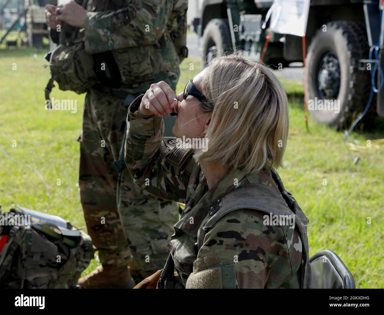 Maj. Stacy Williams, the 39th HHC Brigade Judge Advocate, takes communion during the 39th’s religious service at the Joint Readiness Training Center, Fort Polk, La. July 18, 2021. Stock Photo