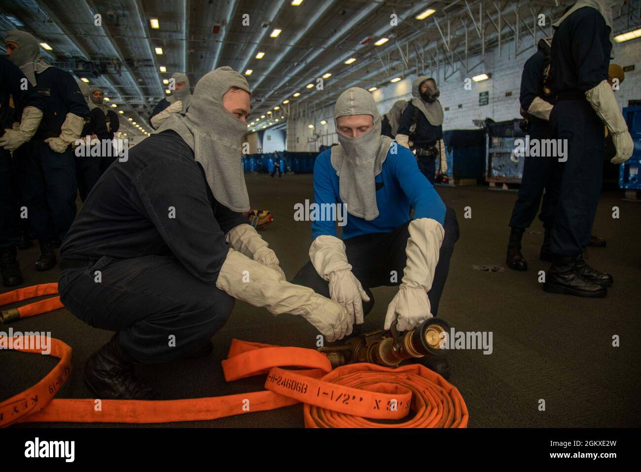 Aviation Boatswain's Mate (Handling) 3rd Class Collin Horsley, left, from Rockswood, Michigan