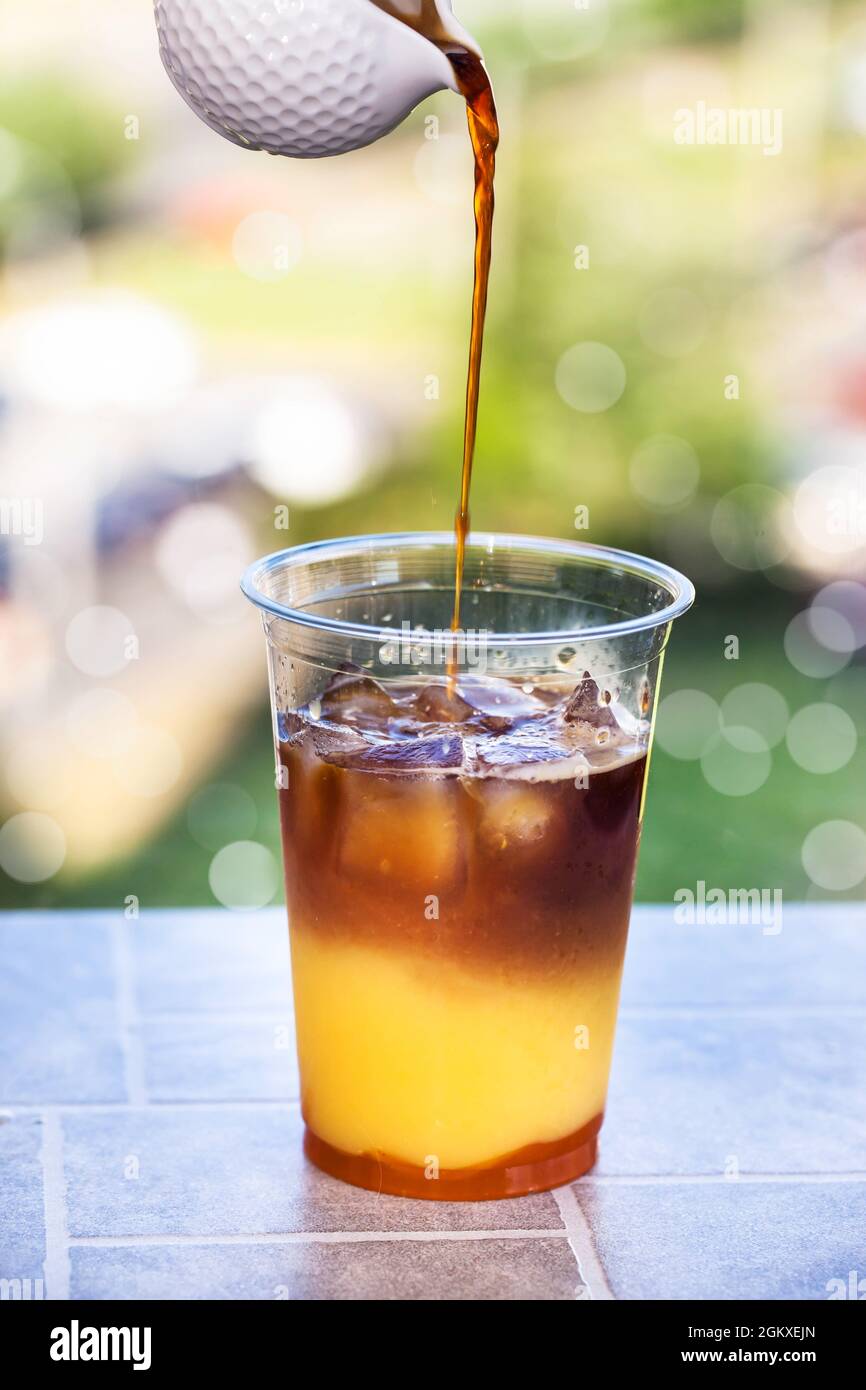 https://c8.alamy.com/comp/2GKXEJN/making-bumble-coffee-refreshment-summer-iced-cocktail-with-espresso-orange-juice-caramel-syrup-and-ice-2GKXEJN.jpg