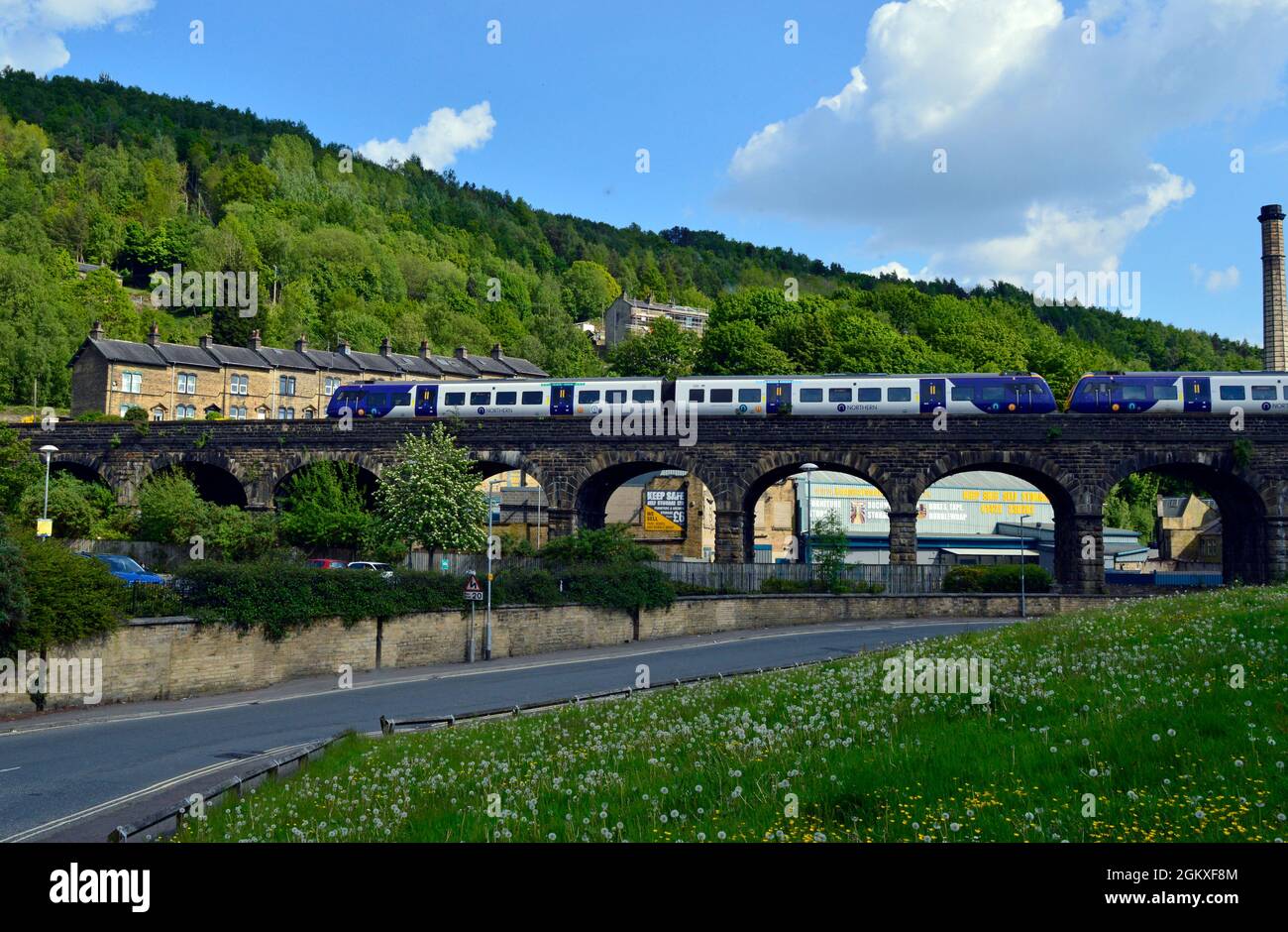 HALIFAX. WEST YORKSHIRE. ENGLAND. 05-29-21. Berry Lane the railway viaduct. Two Northern Rail class 197 DMU's cross with a service for Leeds. Stock Photo