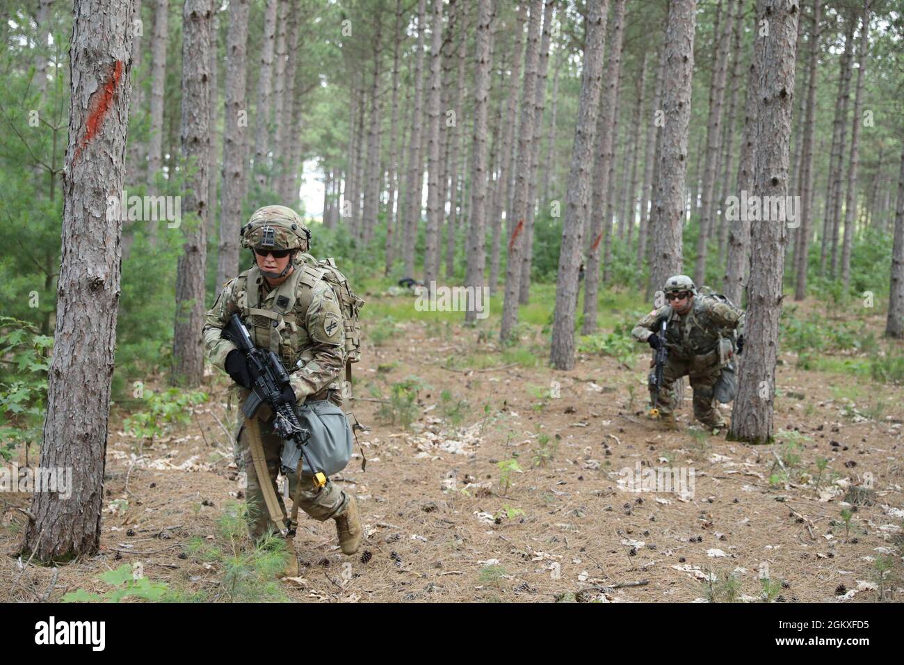 Soldiers of the 16th Psychological Operations Battalion conduct react to contact training during their annual training at Fort McCoy, Wis., July 19, 2021. Soldiers were coached and trained by observer coach/trainers of the 181st Multi-Functional Training Brigade on how to react to enemy fire during squad-based tactical movement. Stock Photo
