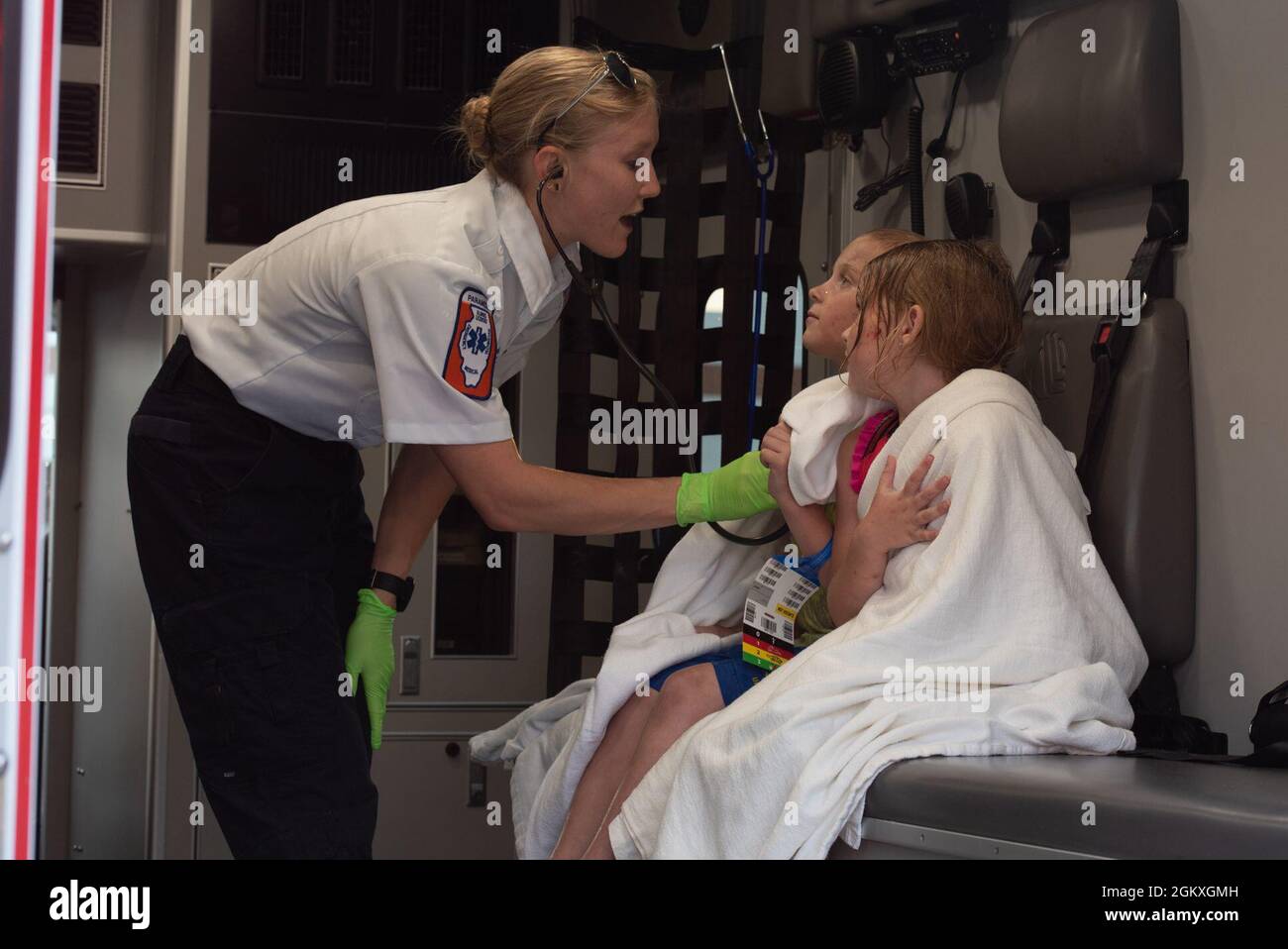 Katherine Kerkhover, paramedic, takes vitals of two simulated victims after a train derailment exercise on Scott Air Force Base, Illinois, July 19, 2021. After taking the vitals of victims, they were transported to a designated imitation hospital where they simulated getting more in-depth treatment. Stock Photo