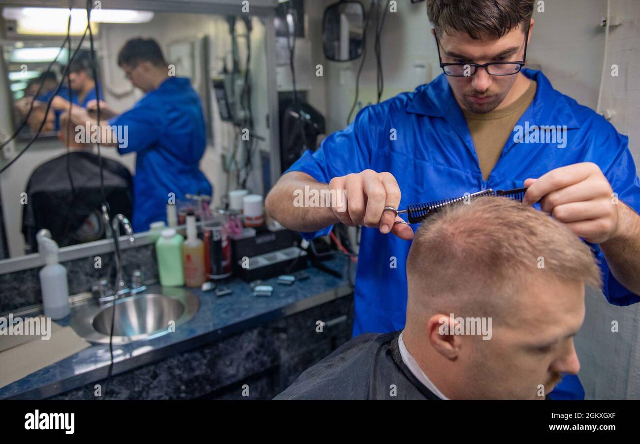 SOUTH CHINA SEA (July 19, 2021) Retail Specialist Seaman Brandon Smith, from Toledo, OH., cuts