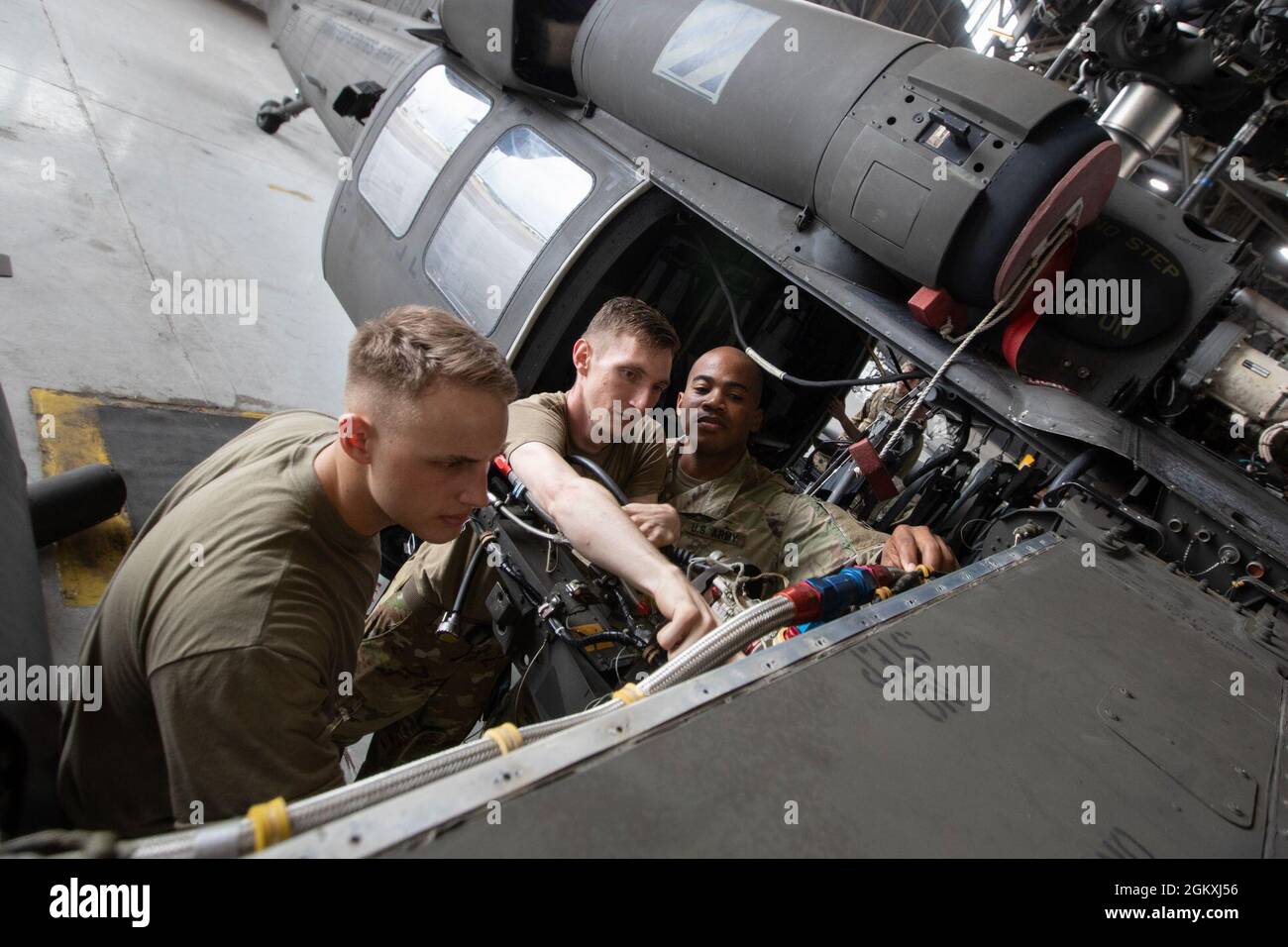 UH-60 Black Hawk helicopter repairers assigned to 2nd Battalion, 3rd General Support Aviation Battalion, 3rd Combat Aviation Brigade, 3rd Infantry Division, conduct maintenance on an aircraft at Hunter Army Airfield, Georgia, July 20. Routine maintenance and inspections are done on aircraft to maintain the brigade's readiness. Stock Photo