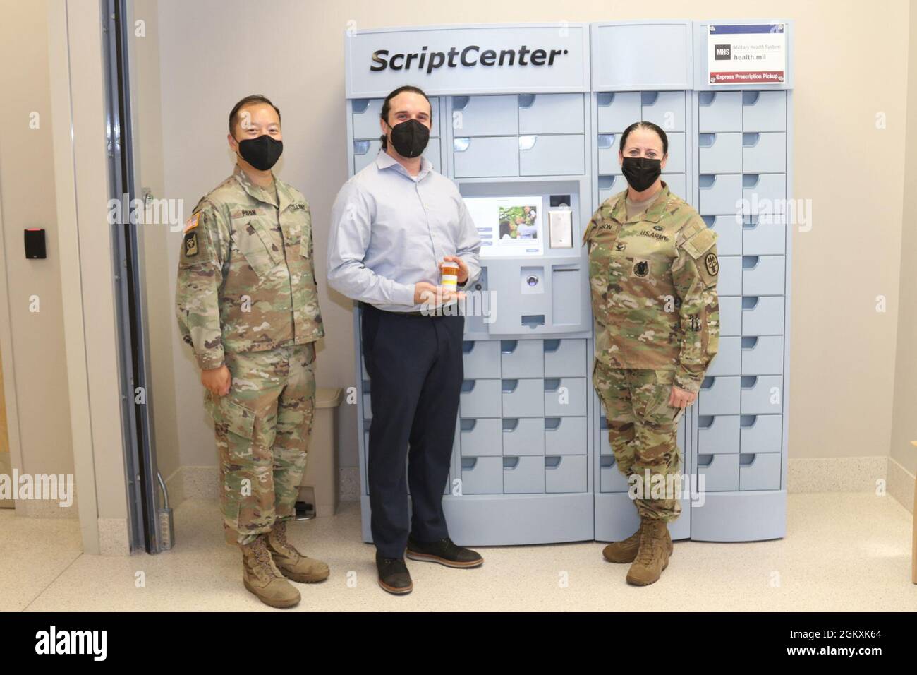 (From left to right) Maj. Lucas Poon, the chief of pharmacy for Weed Army Community Hospital, Ryan Lebowitz, a senior implementation specialist with Asteres, the company that creates ScriptCenter kiosks, and Col. Nancy Parson, the commander of Weed ACH, pose for a photograph with the hospital’s new ScriptCenter kiosk July 20 on Fort Irwin. Stock Photo