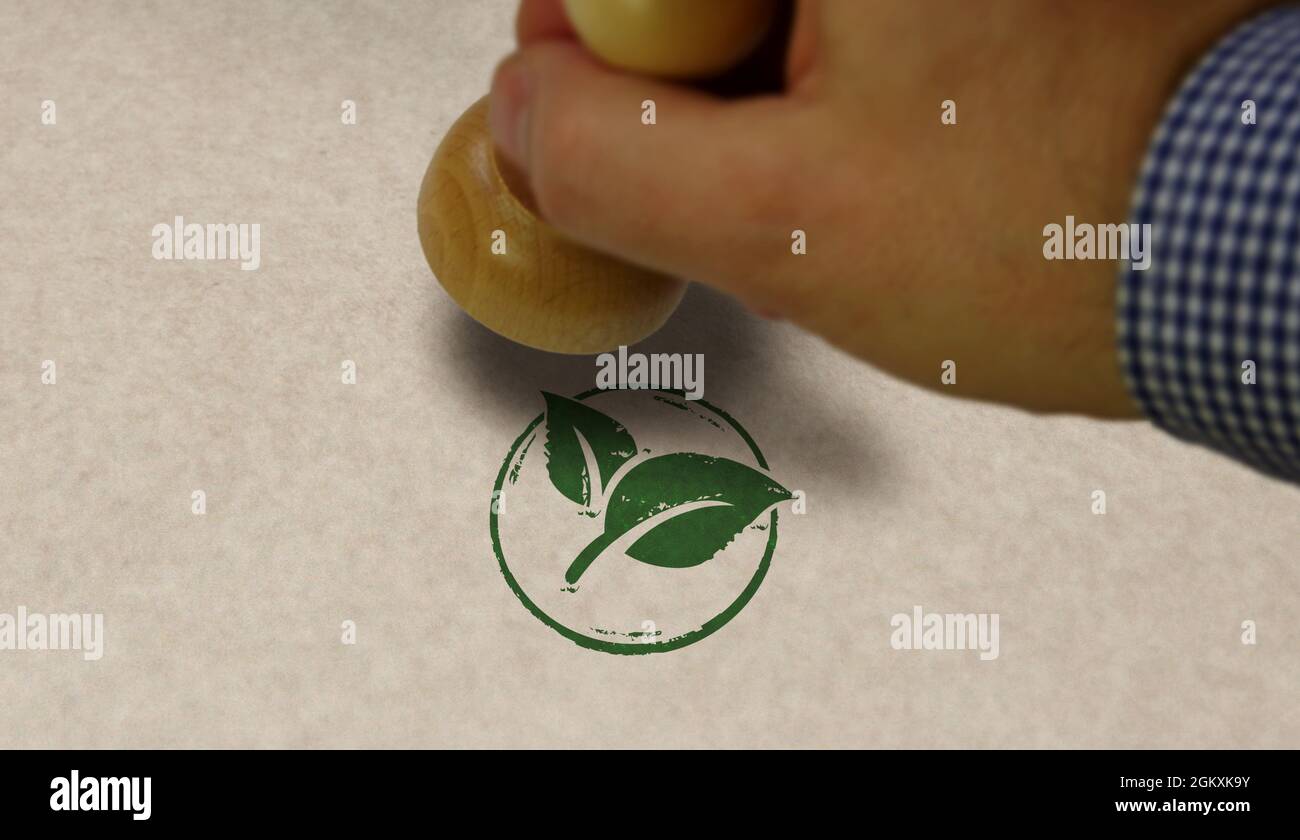 Green leaf eco friendly symbol stamp and stamping hand. Co2 neutral, ecology, environment, nature and climate concept. Stock Photo