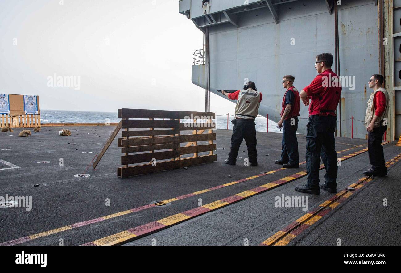 210720-N-NY362-1041 ARABIAN SEA (July 20, 2021) – Sailors participate in an M500 shotgun live-fire qualification course aboard aircraft carrier USS Ronald Reagan (CVN 76) in the Arabian Sea, July 20. Ronald Reagan is deployed to the U.S. 5th Fleet area of operations in support of naval operations to ensure maritime stability and security in the Central Region, connecting the Mediterranean and Pacific through the western Indian Ocean and three strategic choke points. Stock Photo