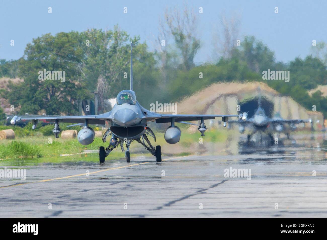 Two U.S. Air Force F-16 Fighting Falcons assigned to the 555th Fighter Squadron taxis on the flightline during Thracian Star 21 at Graf Ignatievo Air Base, Bulgaria, July 20, 2021. Eight F-16s assigned to the 555th FS participated in Thracian Star 21, a Bulgarian air force-led exercise aiming to enhance interoperability and the ability to rapidly deploy to remote locations. Stock Photo