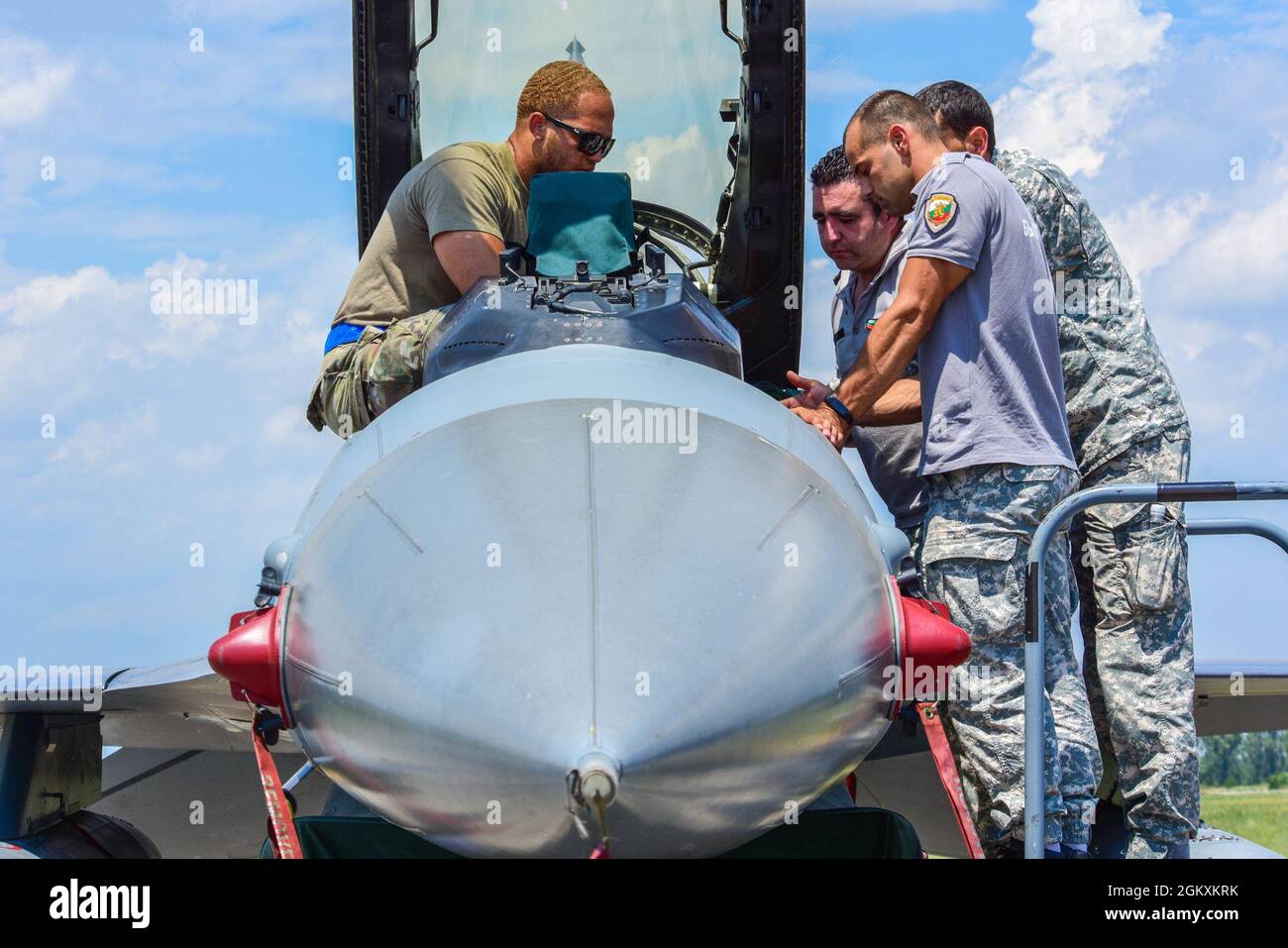 Senior Airman Alexander Smalls, 31st Maintenance Squadron aircrew egress journeyman, left, teaches Bulgarian air force members egress procedures during exercise Thracian Star 21 at Graf Ignatievo Air Base, Bulgaria, July 20, 2021. Thracian Star 21 is a multilateral training exercise with the Bulgarian air force that increases operational capacity, capability and interoperability with Bulgaria. Stock Photo