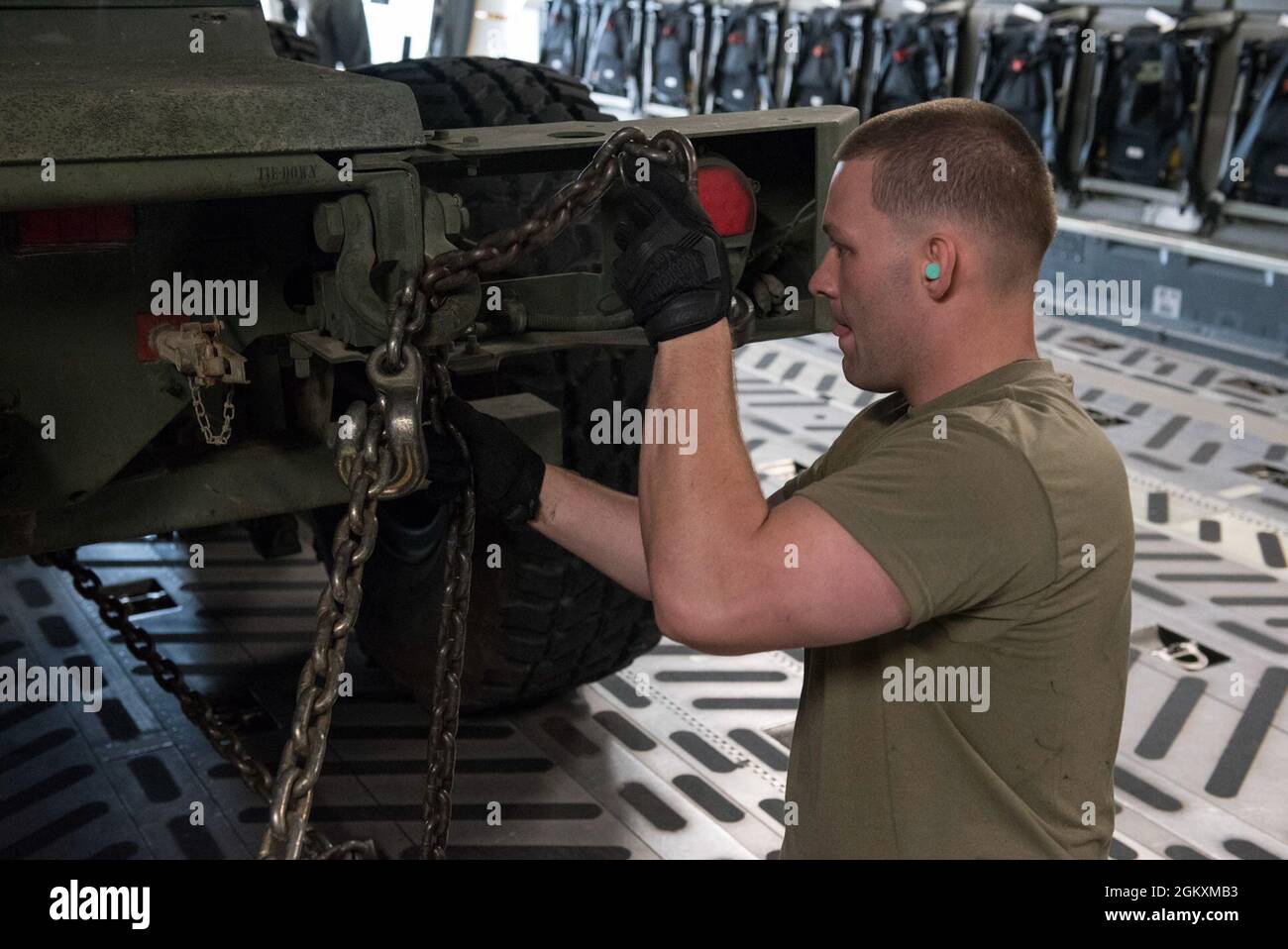 U.S. Air Force Staff Sgt. Jonah Everage, an air transportation specialist with the 123rd Airlift Wing, Kentucky National Guard, secures a U.S. Army High Mobility Artillery Rocket System (HIMARS) vehicle with B Battery, 1st Battalion, 623rd Field Artillery Regiment, Kentucky National Guard, onto a C-17 Globemaster III aircraft with the 167th Airlift Wing, West Virginia National Guard at Bowman Field, Louisville, Kentucky, July 20, 2021, as part of Sentry Storm 2021. Sentry Storm, a joint training exercise hosted by the West Virginia Air National Guard, focuses on Agile Combat Employment (ACE) c Stock Photo