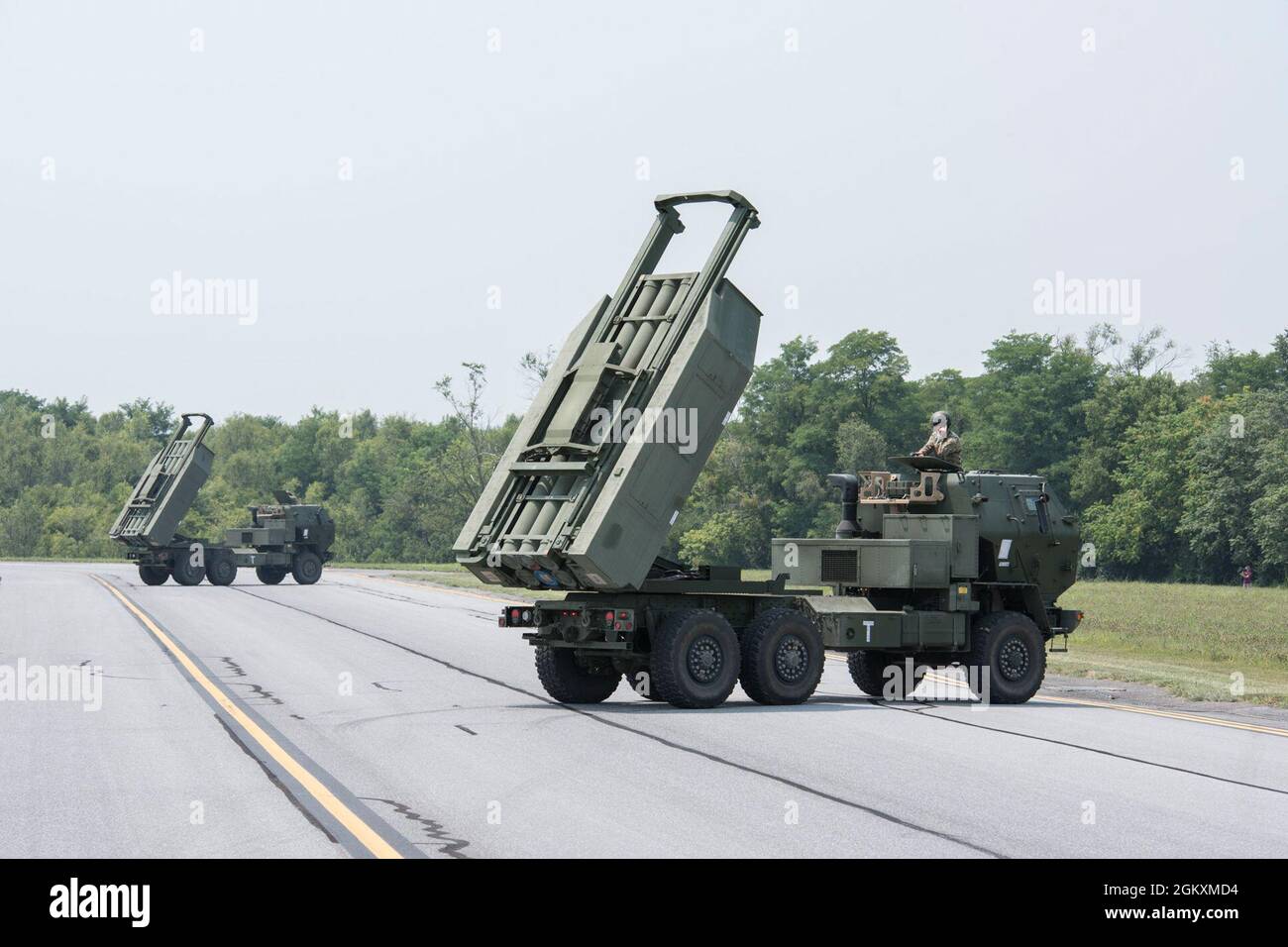 U.S. Army High Mobility Artillery Rocket System (HIMARS) vehicles with B Battery, 1st Battalion, 623rd Field Artillery Regiment, Kentucky National Guard, conduct a simulated firing exercise on the airfield at Shepherd Field Air National Guard Base, Martinsburg, West Virginia, July 20, 2021, as part of Sentry Storm 2021. Sentry Storm, a joint training exercise hosted by the West Virginia Air National Guard, focuses on Agile Combat Employment (ACE) concepts allowing participants to hone skills needed to prevail over near-peer competitors. A variety of aircraft including C-130 Hercules, C-17 Glob Stock Photo