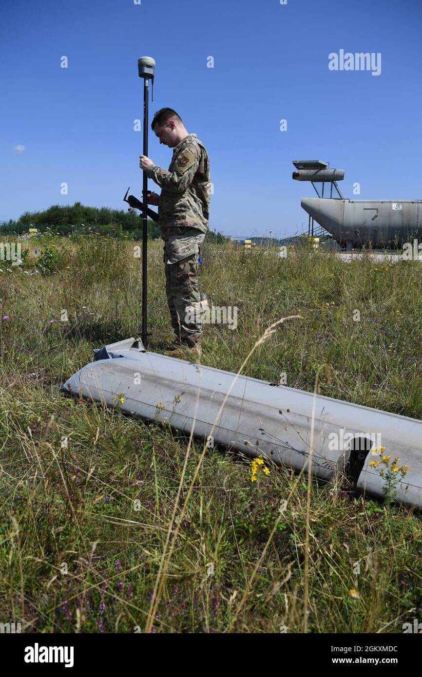 U.S. Air Force Airman 1st Class Gage Sarrett, 86th Civil Engineering Squadron engineering apprentice surveys a simulated debris field during an exercise, Operation Varsity 21-3, at Ramstein Air Base Germany, July 20, 2021. Sarrett was a part of the crash survey team for a simulated aircraft crash site during the Operation Varsity exercise. Stock Photo